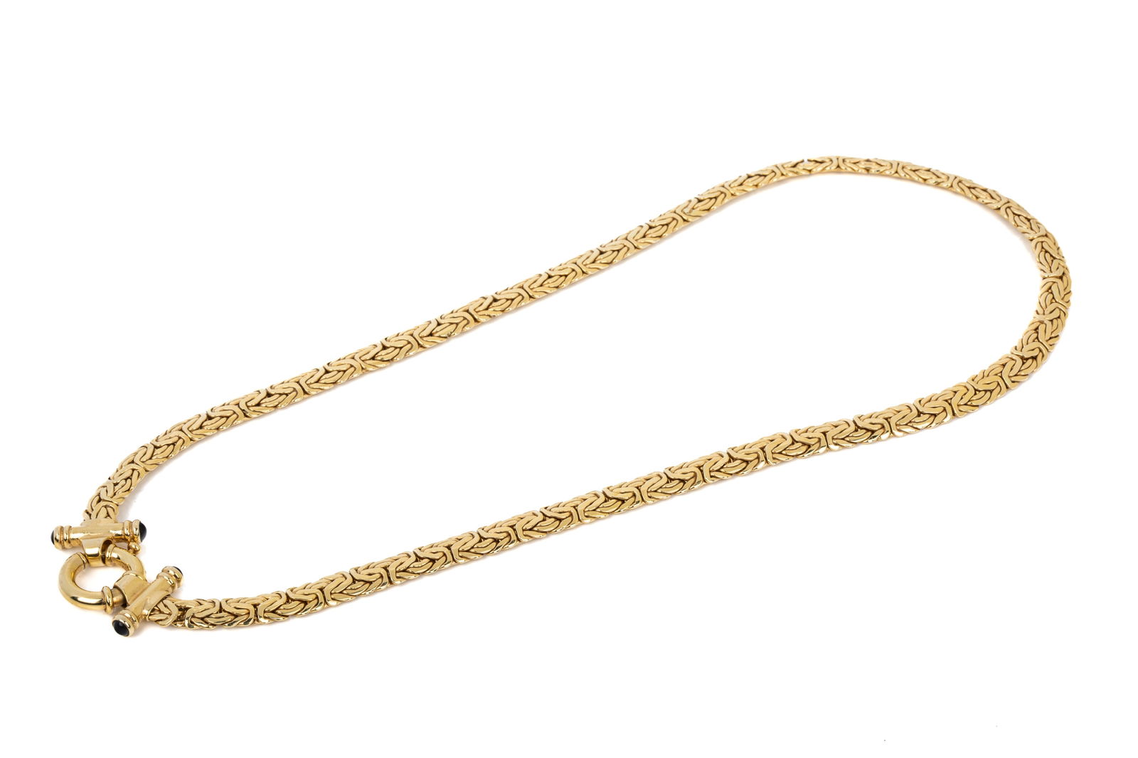 14K YELLOW GOLD FLAT KINGS LINK NECKLACE 27.3g: Measuring 19.25 inches long by 7mm wide by 2.7mm thick, featuring stylized statement clasp accented with round cabochon cut very dark blue sapphires. Very good condition. 27.3 grams
