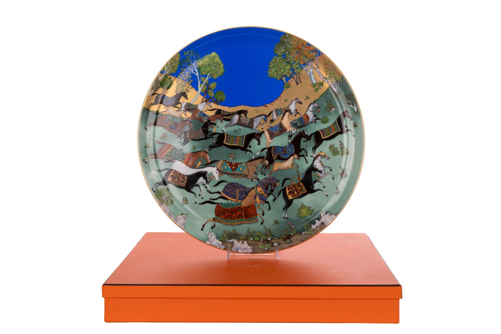 LARGE HERMES PORCELAIN CHARGER DISH: Cheval d'Orient pattern, running horses with colourful saddle blankets, gold background, with original box, France, 21st C. Dia 44.5cm (17 2/1in)