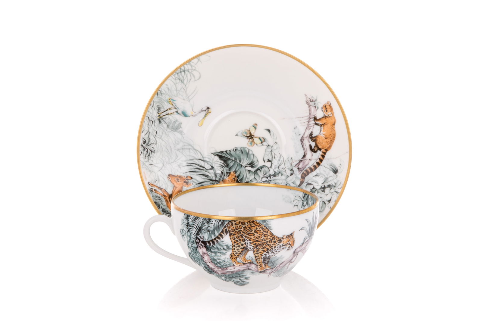 HERMES PORCELAIN BREAKFAST CUP & SAUCER: Carnets D'Equateur pattern with wild animals and gilt rim. Hermes France, 21st C. Dia of saucer 18cm (7in)