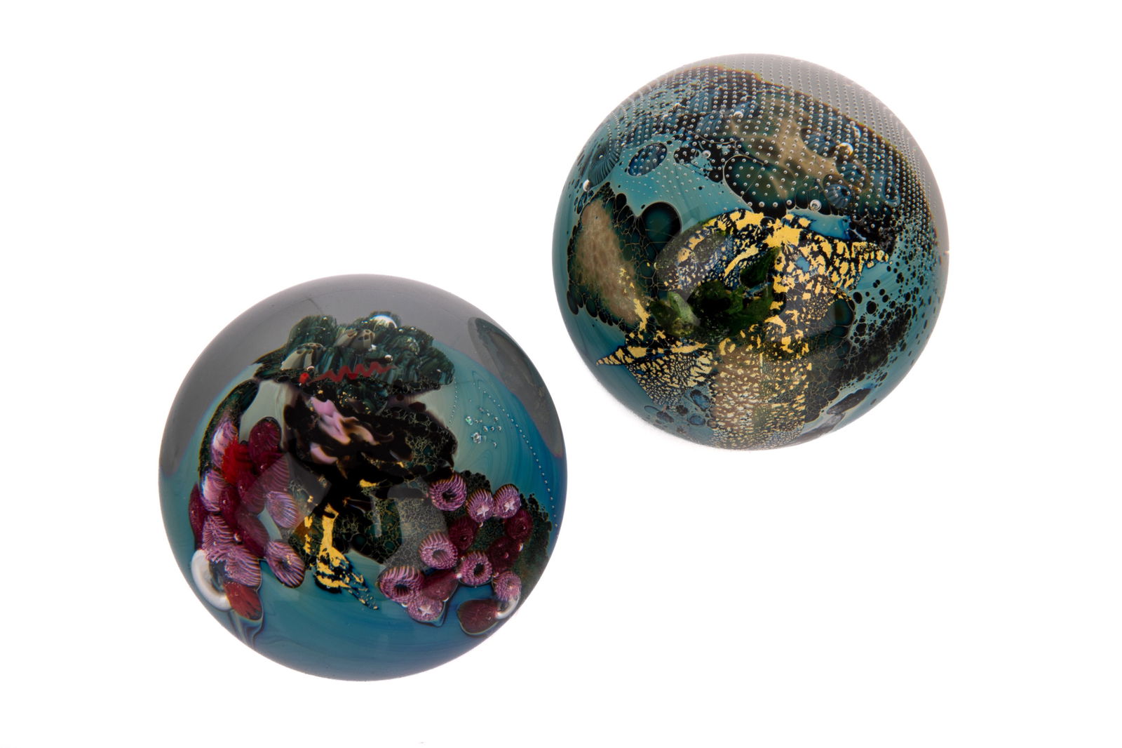 TWO JOSH SIMPSON STUDIO GLASS PAPERWEIGHTS: Including a coral underwater with fish and world paperweight, both signed and dated. Dia. 6.9cm (2 3/4in) Dia. 7.3cm (2 7/8in)