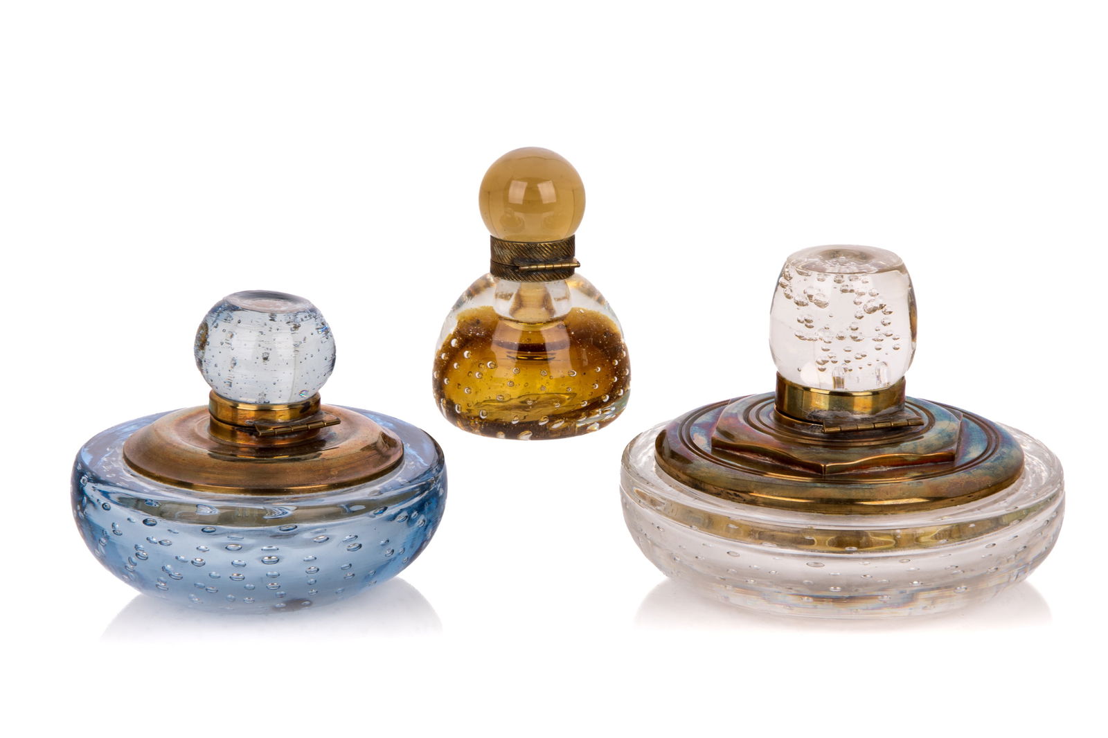THREE VINTAGE MURANO BUBBLE GLASS INKWELLS: In blue, clear and amber glass with brass heavy mounts. Dia of clear largest 15cm (6in)