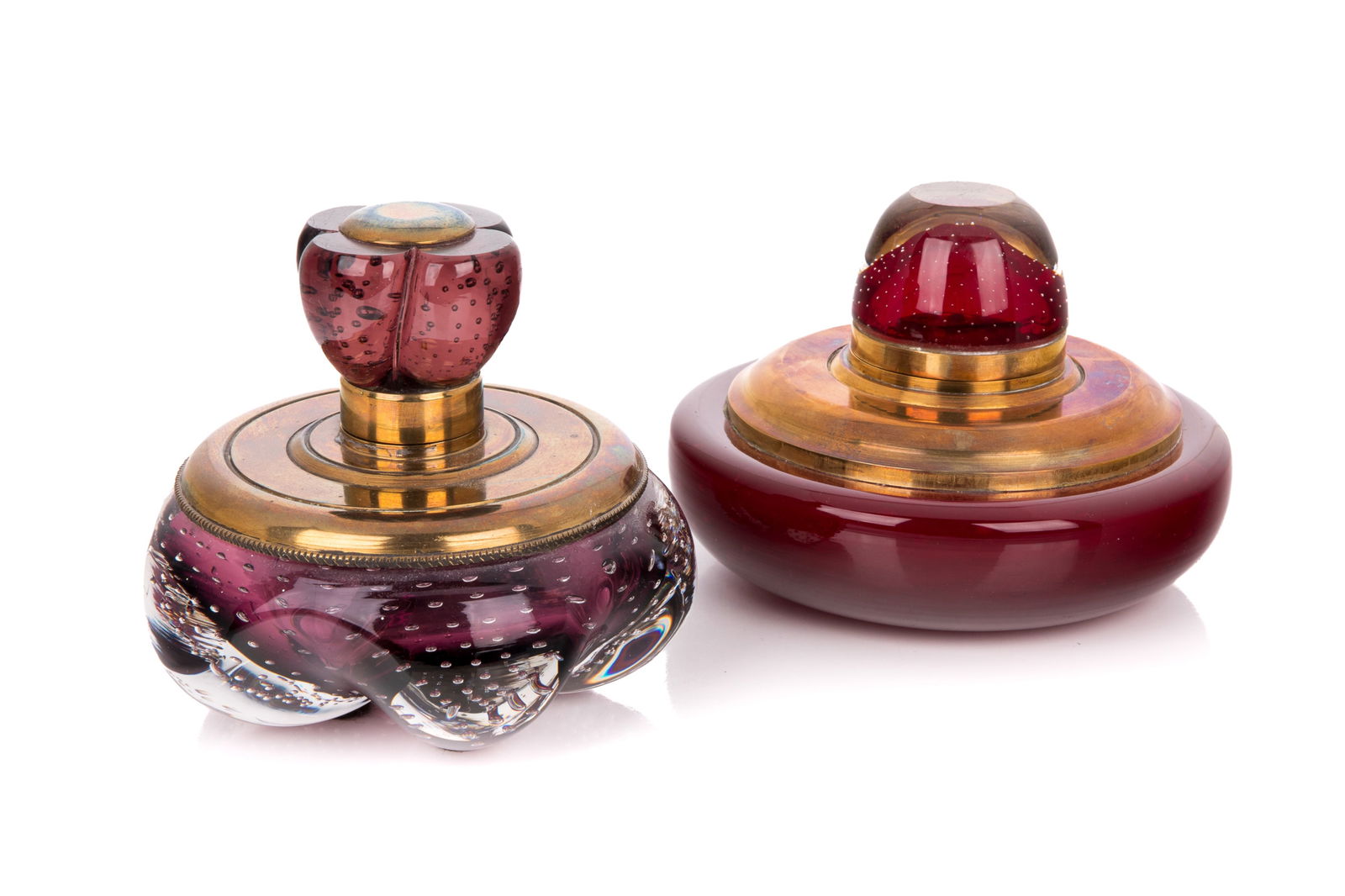 TWO VINTAGE MURANO BUBBLE GLASS INKWELLS: In red and amethyst purple glass with heavy brass mounts. Dia of red 15cm (6in)