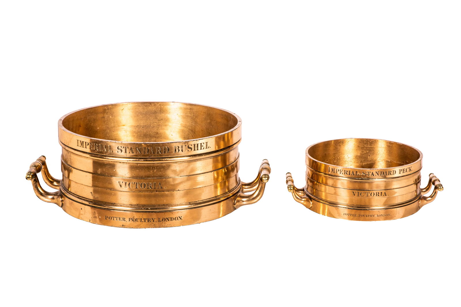 TWO 19th C ENGLISH BRONZE MEASURES: Imperial Standard Bushel Victoria, Potter Poultry, London. And Imperial standar pec, Bushel Dia. 49cm (19 3/8") W. from handles 66cm (26"), Pec Dia. 31cm (12 1/4") W. from handles: 42cm (16 1/2"