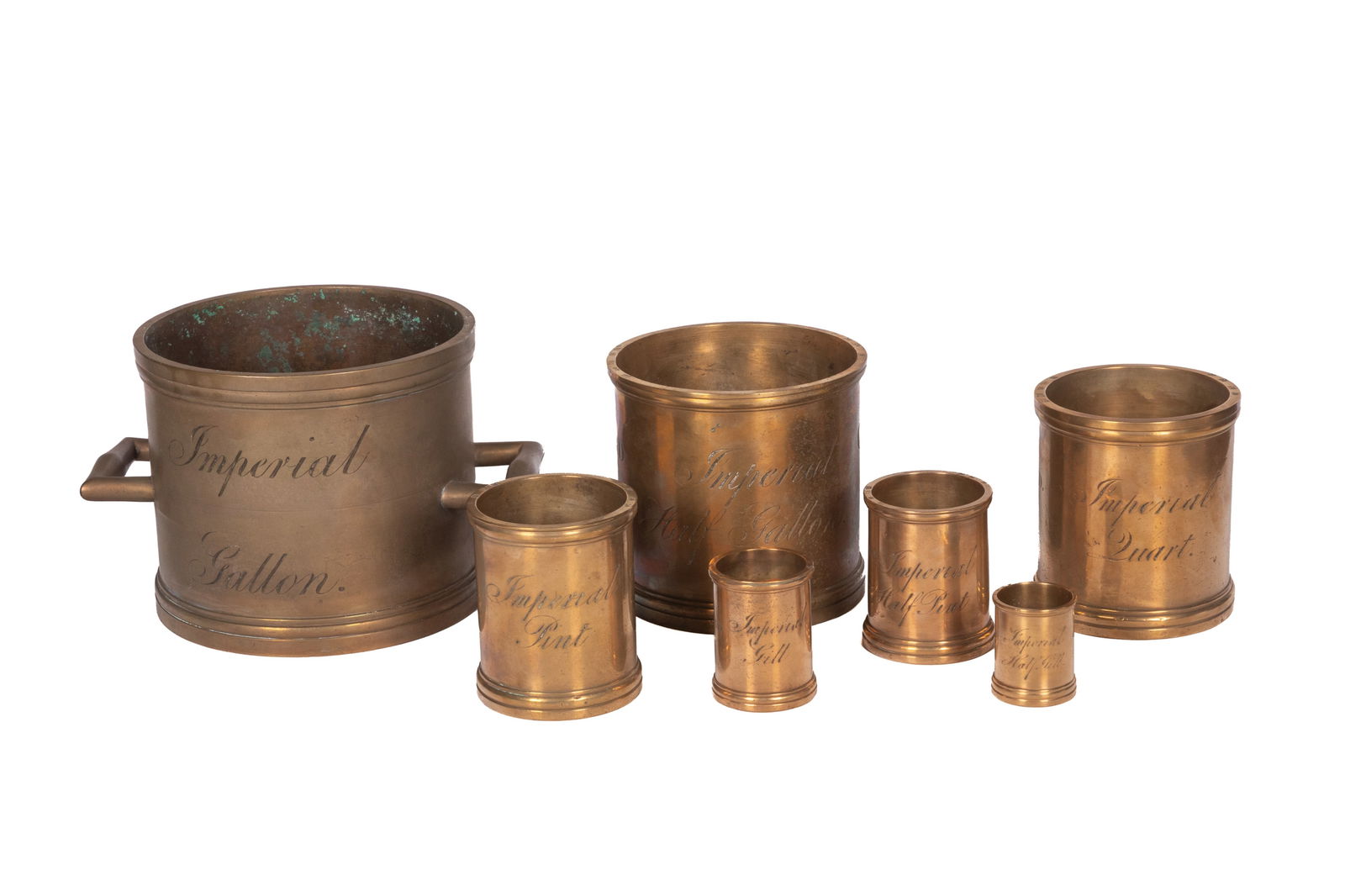 SEVEN 19th C ENGLISH BRONZE MEASURES: County of Hereford 1825 Including Imperial Gallon, Half Gallon, Quart, Pint, Half Pint, Gill, Half Gill. Dia. of the largest 20.5cm (8") to handles 28 cm (11") H. 17cm( 6 3/4")