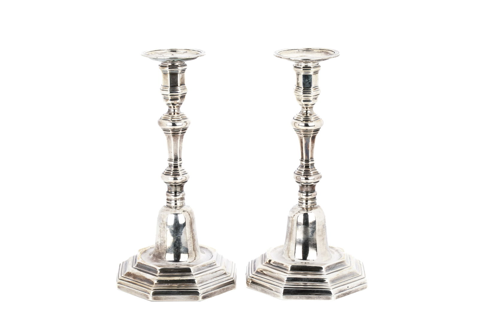 19TH CENTURY FRENCH SILVER CANDLESTICK, 953g: A pair of French silver (800 standard) candlesticks made after 1838. The hexagonal stems rise from an elongated domed hexagonal base. No apparent maker's mark, The bases marked with the second standar