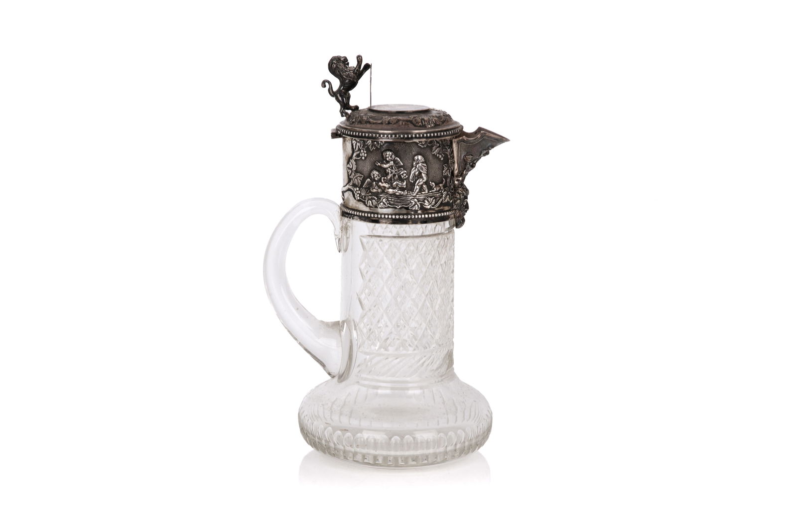 ANTIQUE CUT GLASS PITCHER WITH STERLING MOUNTS: Diamond pattern cut glass pitcher, classical silver lid with dancing putti, lion passant with shield, continental silver mounts, .925 grade. Silver collar not weighable. H. 11" (28cm)