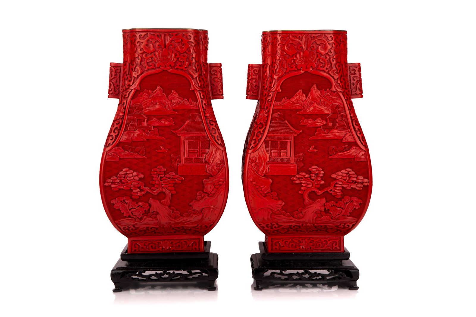 PAIR Of CHINESE CINNABAR HU VASES: Carved red lacquer vases with landscape design and wood stands. 20th C H of vase 30.5cm (12in)