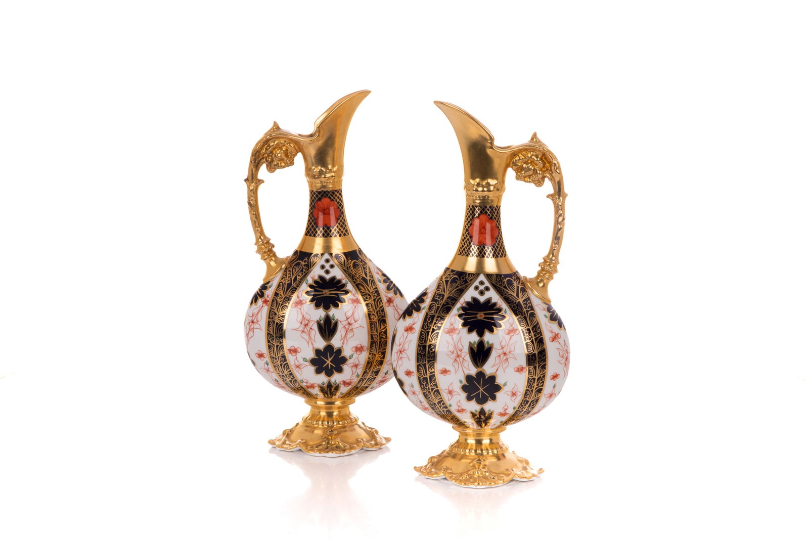 PAIR OF ROYAL CROWN DERBY IMARI PORCELAIN EWERS: Pattern number 1128, with gilded tops and handles. H 25cm (10in)