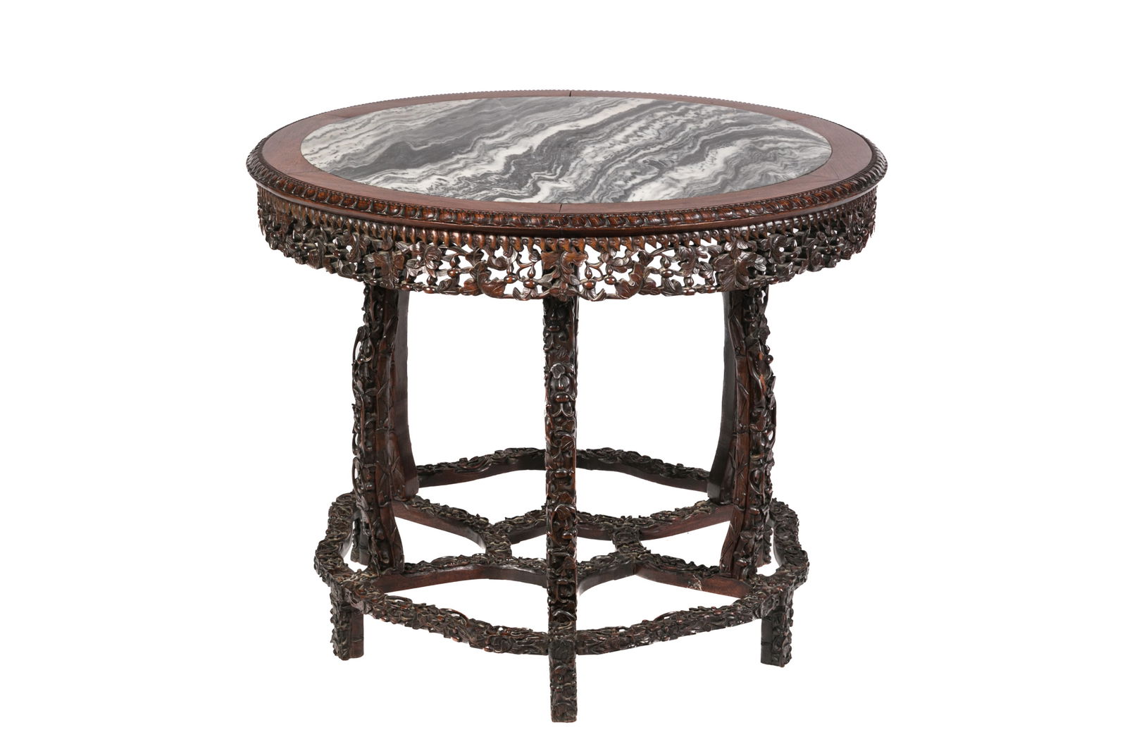 CHINESE FINELY CARVED HARDWOOD CIRCULAR TABLE: Chinese, 19th to early 20th century, a hardwood carved round table with intricate details to apron and legs, having a circular marble insert to the table top. H. 72cm. (28 1/4); Dia. 87.5cm. (34