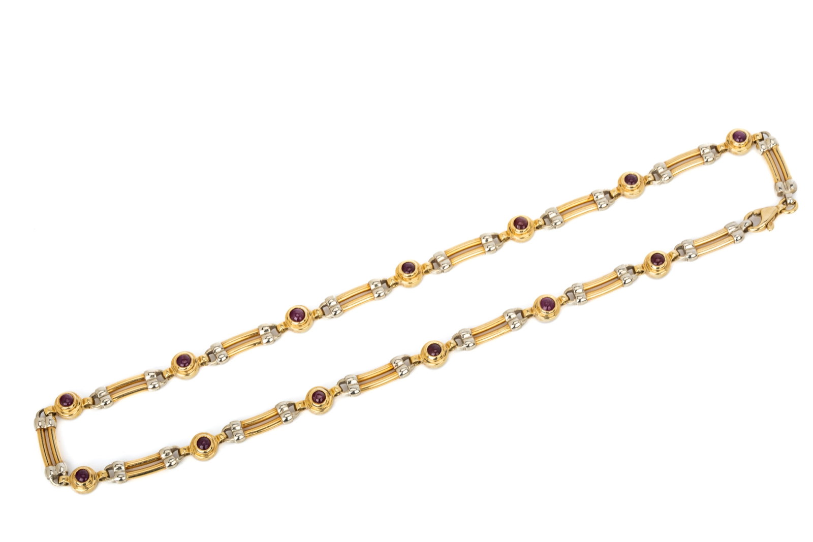18K GOLD & RUBY CABOCHON NECKLACE 37.6g: 18K yellow and white gold necklace measuring 17 inches long by 5.9mm wide Featuring bezel set opaque ruby cabochons 37.6 grams