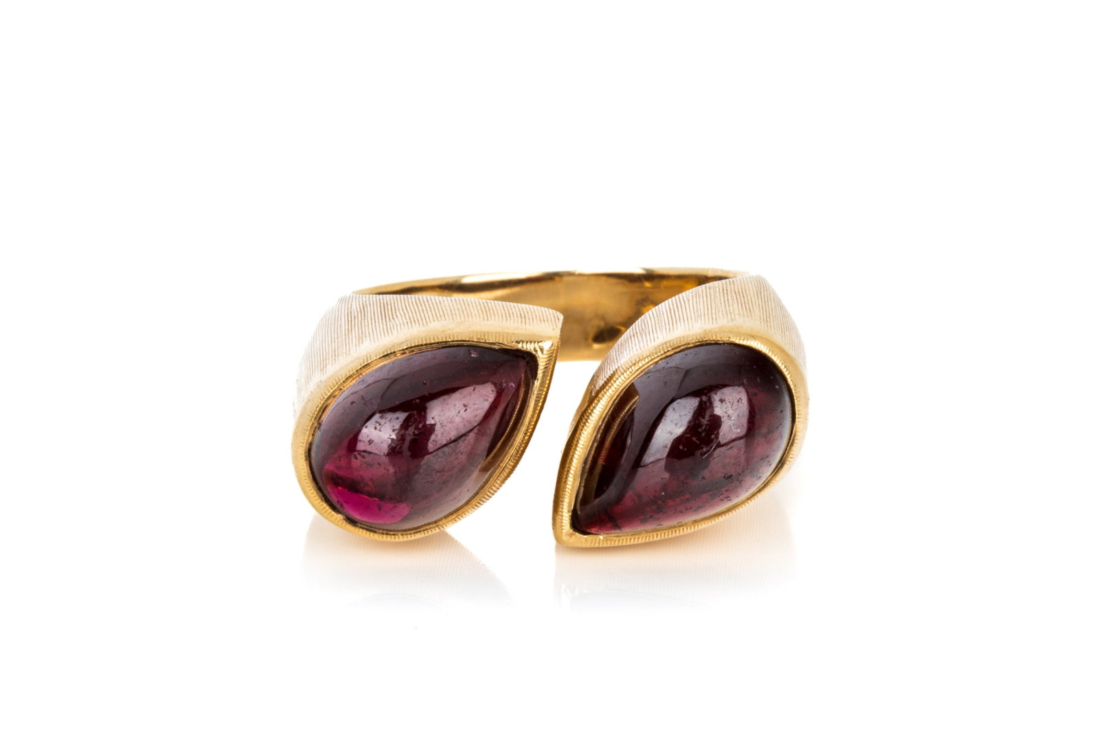 18K GOLD OPEN-TOP GARNET RING 9.5g: Yellow gold open-top ring testing approximately 18K, measuring 9.9mm wide by 8.9mm tall. Featuring 2 pear shaped cabochon cut garnets, measuring approximately 10.5 x 7mm (average ofboth). Size 6.5 (ap
