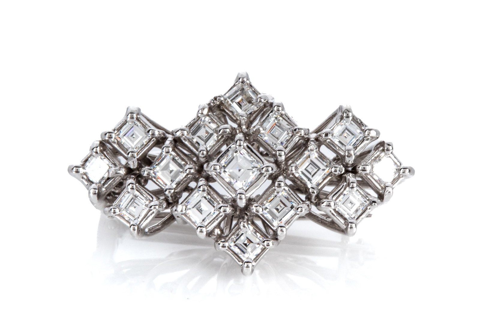 VINTAGE 14K 1.53cttw CARRE CUT DIA. BROOCH 10.1g: Vintage 14K white gold brooch measuring 34.5mm long by 20.4mm wide, equipped with heavily hinged double brooch pin, with 1 roll lock and 1 C clasp. The brooch features 15 carre cut diamonds weighing a