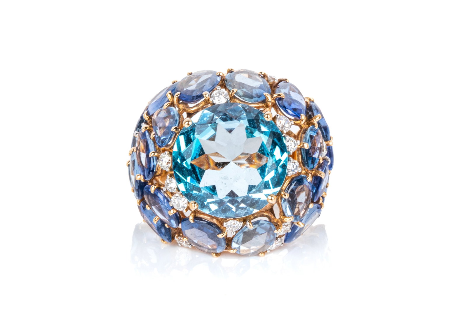 18K CASATO ITALIAN TOPAZ, TANZANITE & DIA. RING 9g: 18K rose gold Italian-made Casato Gioielli statement ring measuring 23.3mm wide by 9.9mm tall. Featuring 1 round brilliant cut Swiss blue topazmeasuring approximately 14mm in diameter. Accented by 20 