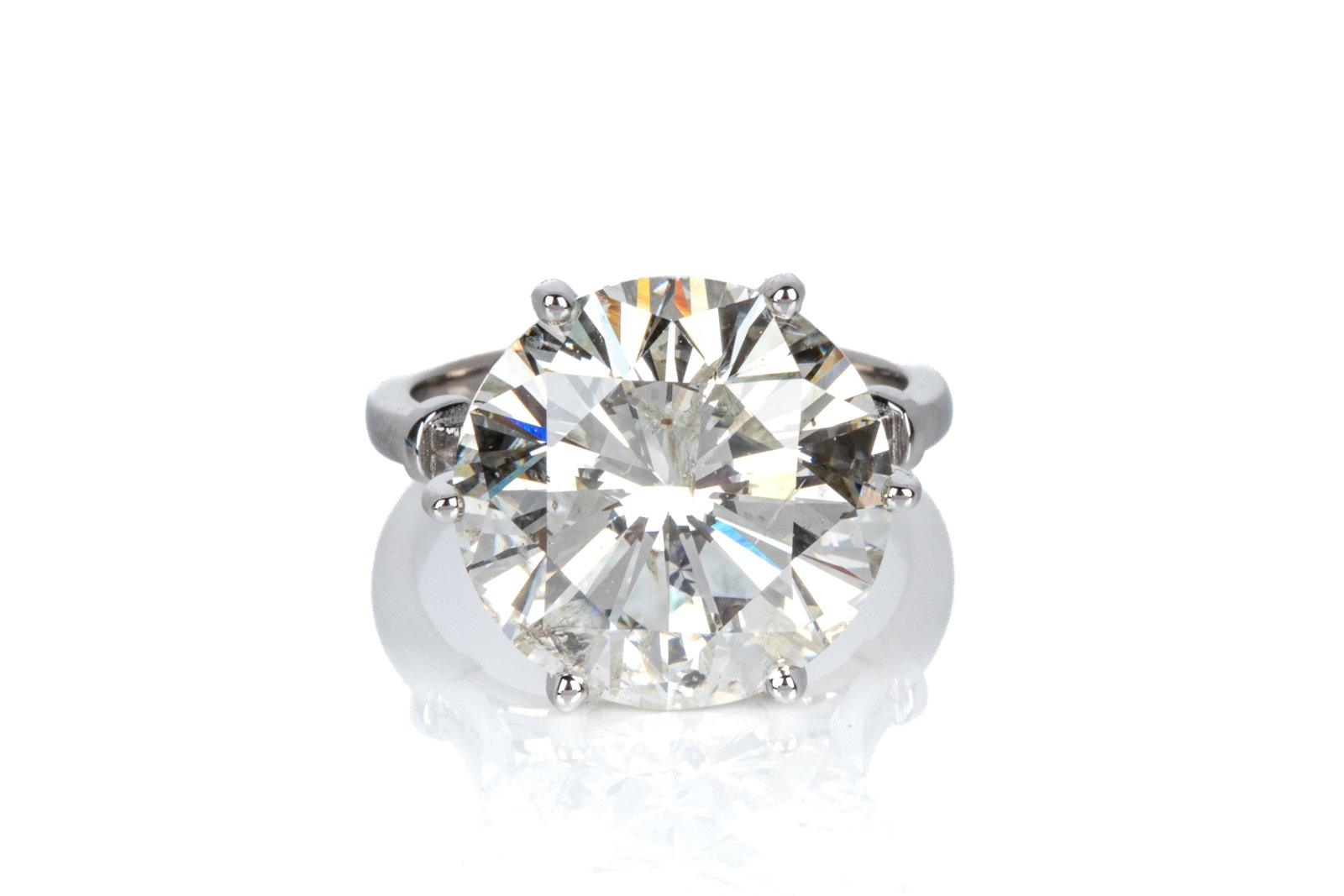 12.52ct I2-JK NATURAL ROUND DIAMOND RING: Natural round brilliant cut diamond weighing 12.52ct (by scale) of I2-JK quality, Good cut, Very Good symmetry, Excellent/Very Good polish, faint fluorescence, measuring 14.94-15.00 x9.16mm. Set into 