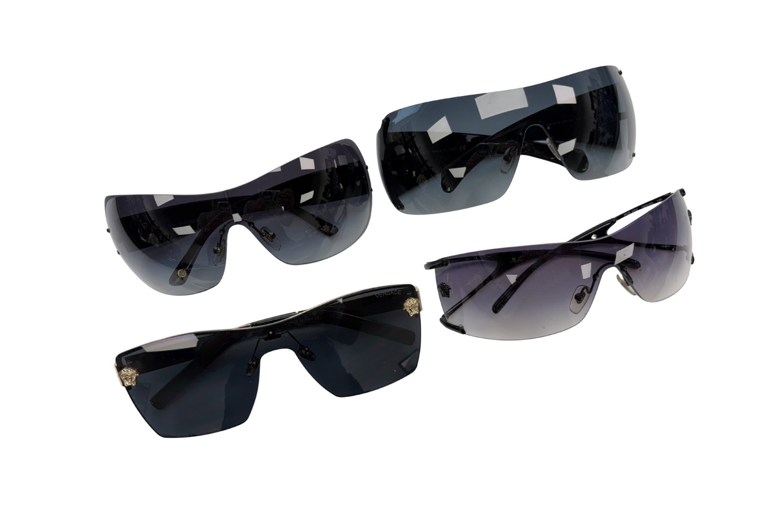 FOUR PAIRS OF VERSACE SUNGLASSES: Including a pair of aviator style sunglasses under the model and colour codes 2154 136 140, and three pairs of shield style under 4225K GB1 8G (limited edition), 2052 1009 8G, and 4115 GB1 8G.All made