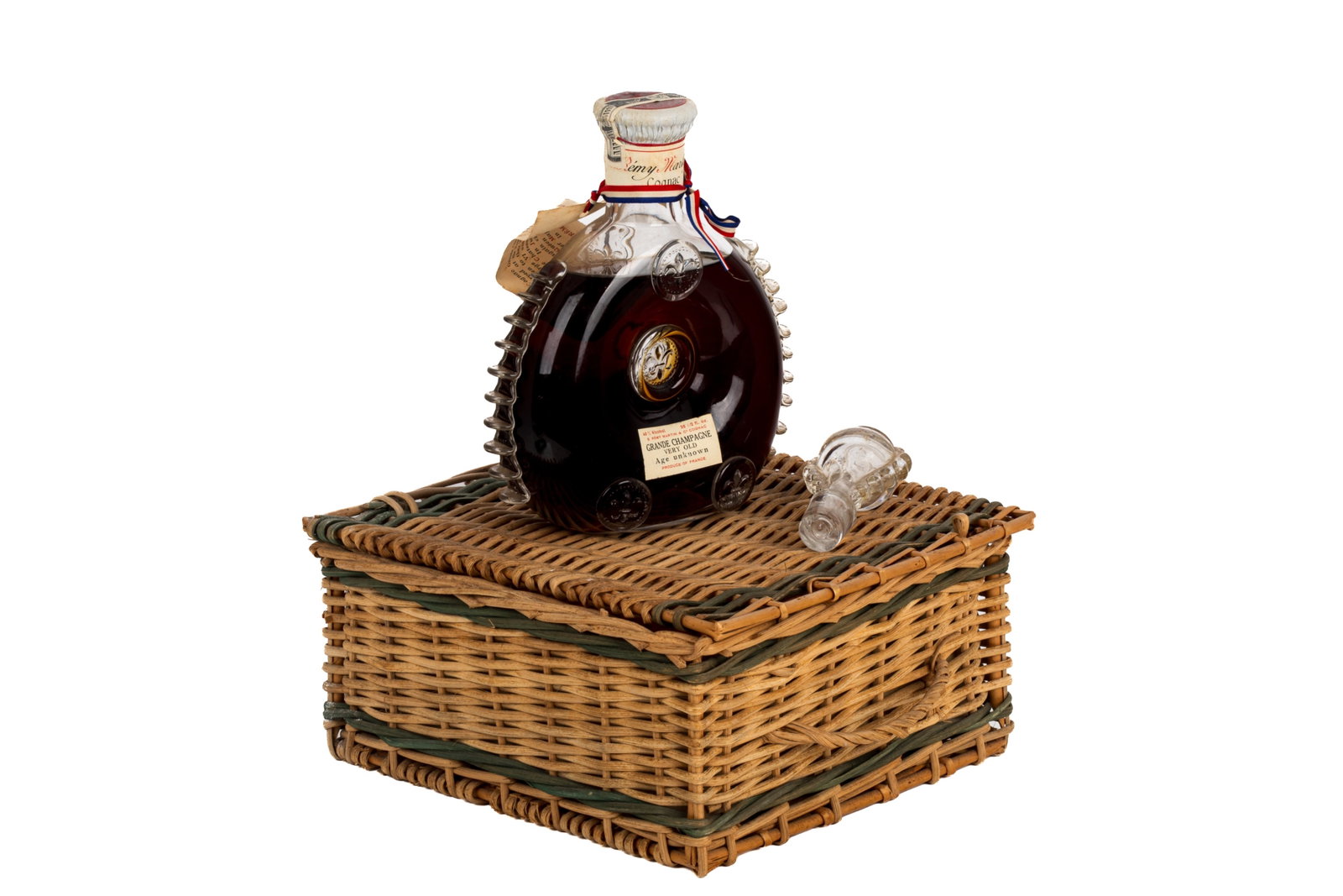 REMY MARTIN LOUIS XIII COGNAC GRANDE CHAMPAGNE: Presented in a Baccarat cut-glass decanter, which is an exact replica of a flask discovered on the site of the battle fought at Jarnac in 1569. Features raised fleur-de-lys emblems.Cognac is a blend