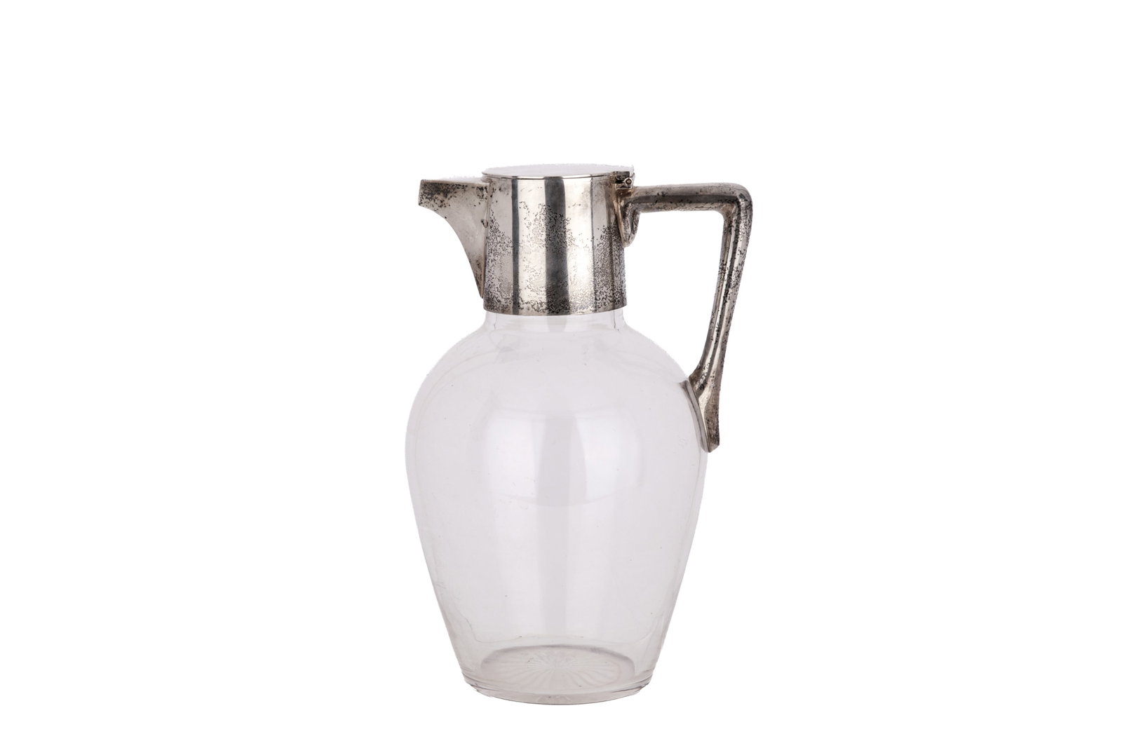 ENGLISH SILVER AND GLASS CLARET JUG: 1 vintage claret jug with a clear glass body and a silver handle, lid, and mount (glass included in weight).H. 8in x W. 4 1/2in (20.3cm x 11.4cm)