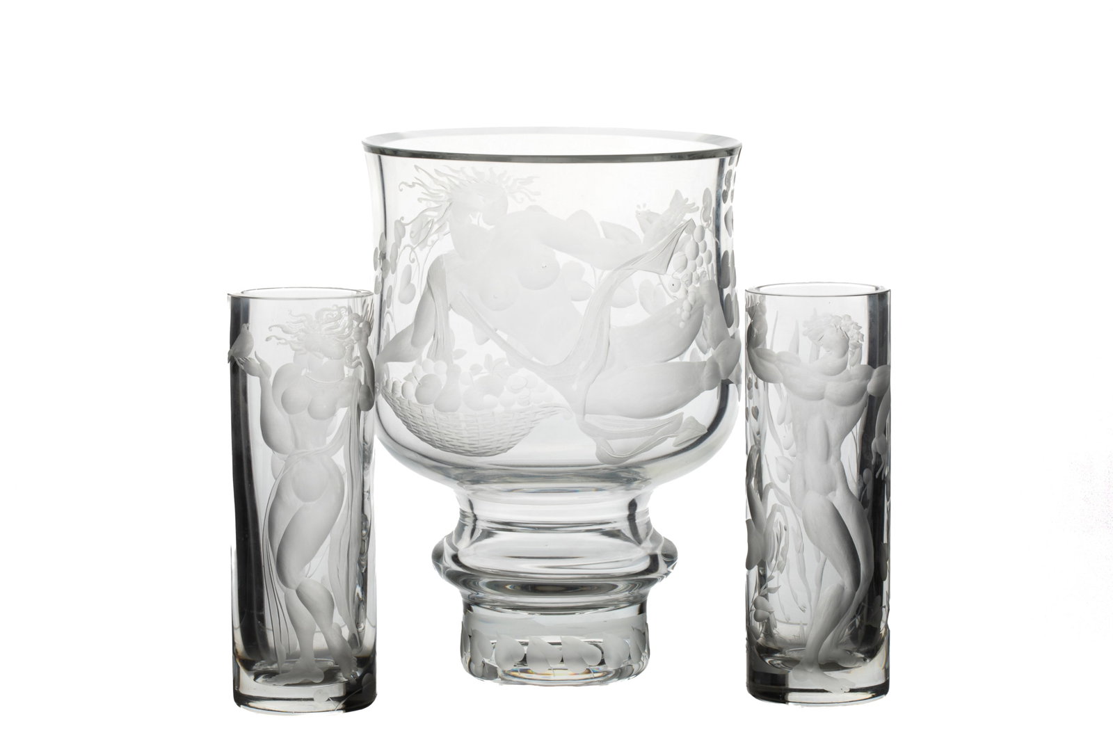 MODERN CZECH GLASS GARNITURE BY KOCICA: This is a modern Czech glass garniture by Kocica. Includes 1 clear crystal vase featuring a female figure with fruit and leaf designs; 2 smaller crystal glasses, one featuring a male figure witha