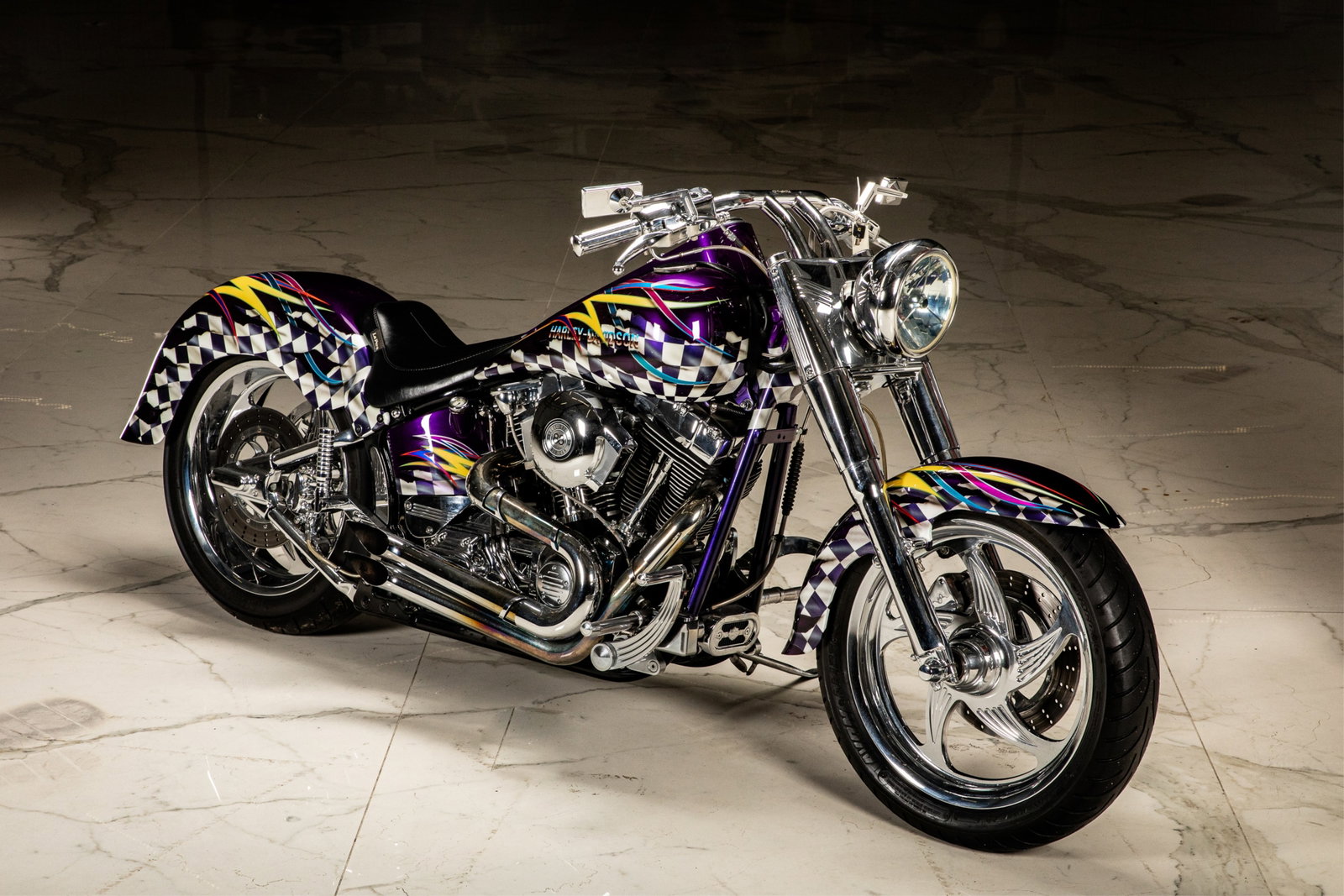 HARLEY DAVIDSON FAT BOY CUSTOM MOTORCYCLE: Checkered paint job with yellow and purple ribbons. VIN illegible, under paint