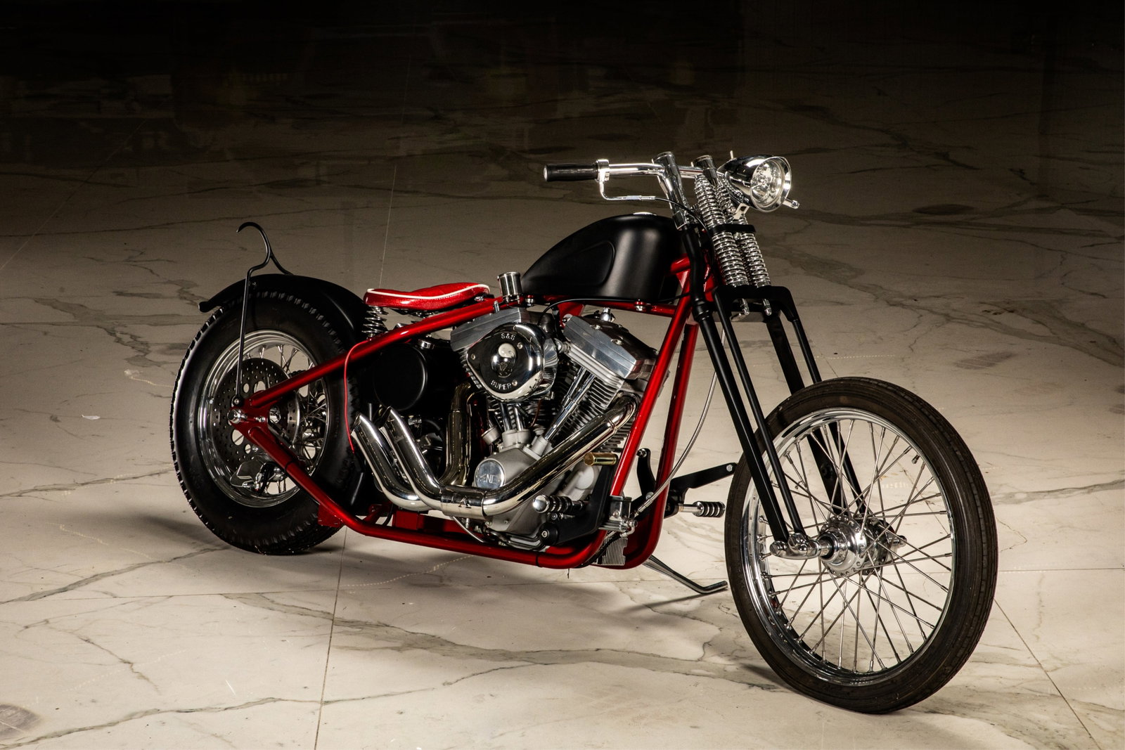 CUSTOM V-TWIN BOBBER MOTORCYCLE: In red paint.