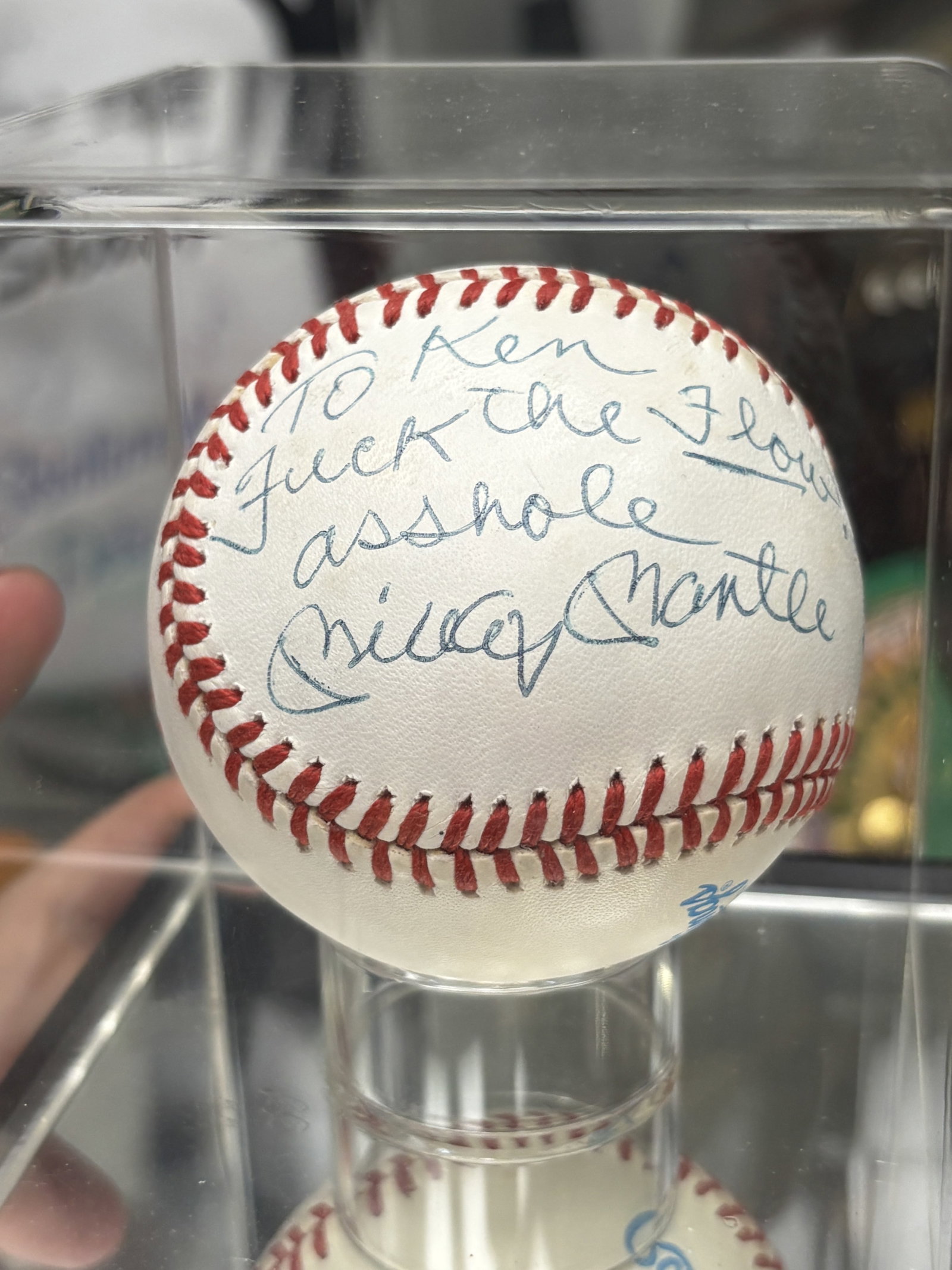 AUTOGRAPHED MICKEY MANTLE BASEBALL: Rawlings American League (brown) baseball signed and inscribed in blue ballpoint "To Ken, Fuck the Flow! Asshole, Mickey Mantle" With PSA/DNA authenticity certificate.