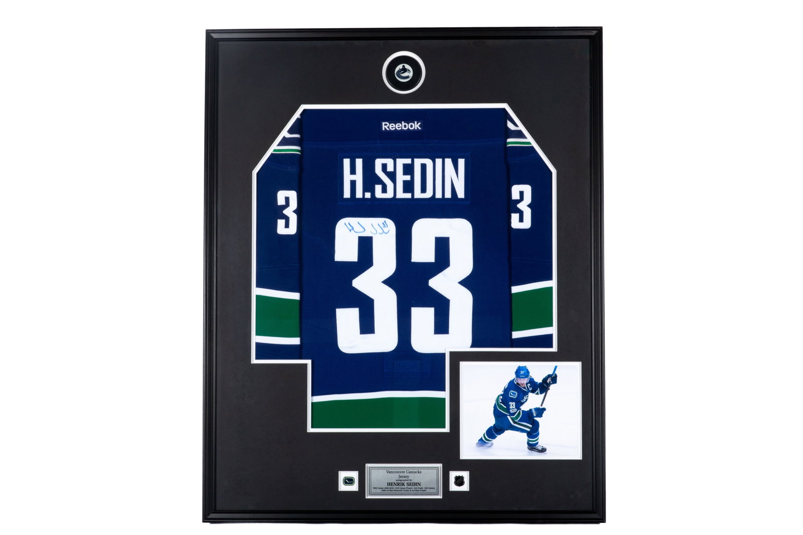 HENRIK SEDIN FRAMED AUTOGRAPHED JERSEY: Henrik Sedin signed #33 Vancouver Canucks jersey. Framed measurements: H. 41 1/2" x W. 33 1/2" This lot does not come with a Letter or Certificate of Authenticity.