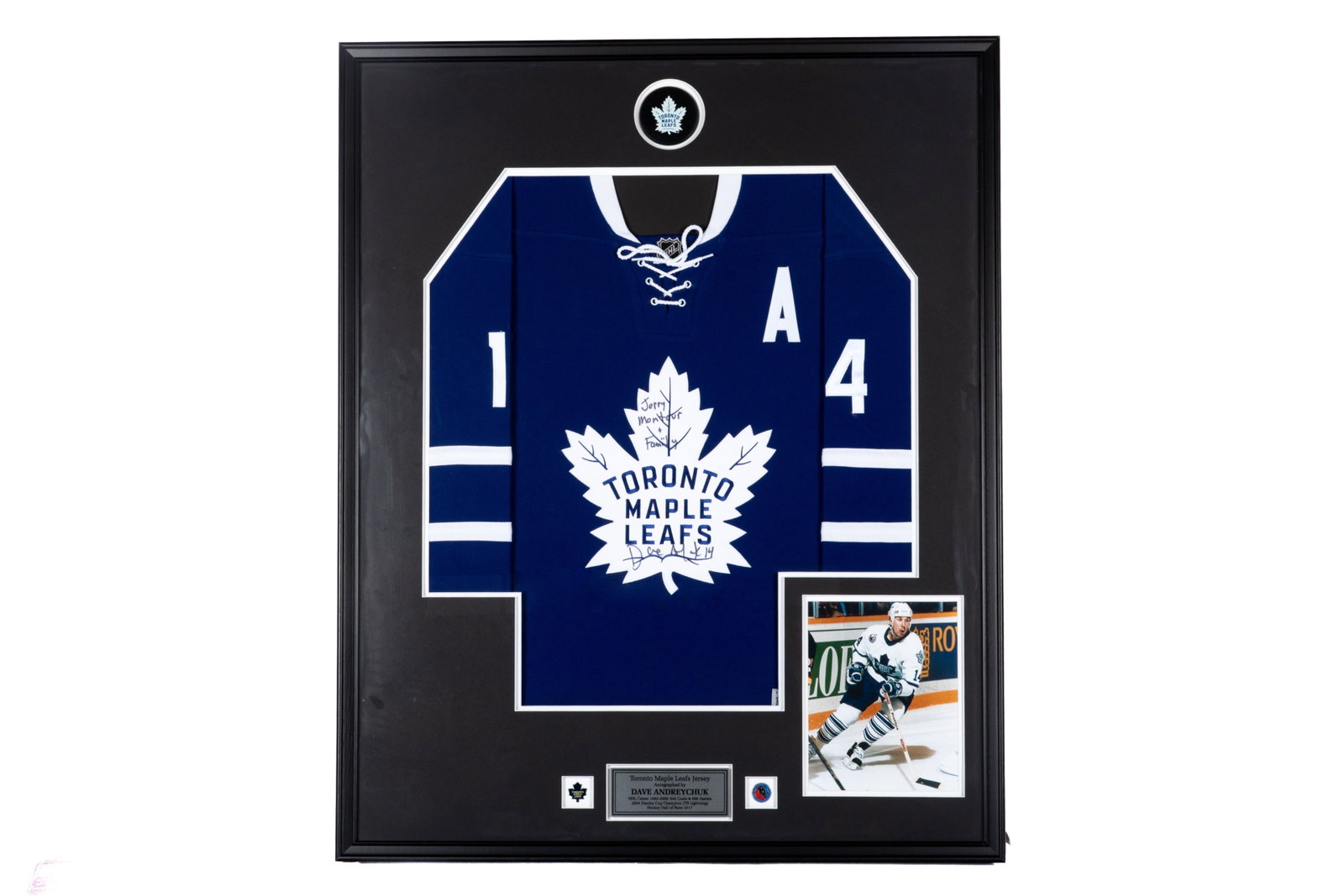 DAVE ANDREYCHUK FRAMED SIGNED JERSEY: Inscribed #14 Toronto Maple Leafs jersey: "Jerry Montour + Family / Dave Andreychuk 14". Framed measurements: H. 41 1/2" x W. 33 1/2" This lot does not come with a Letter orCertificate of