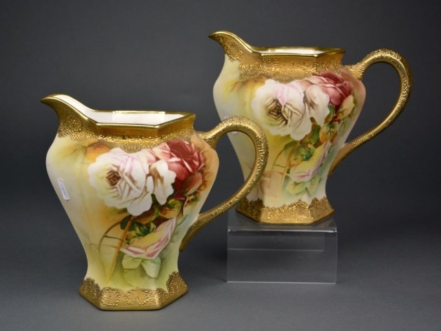 Pair Nippon porcelain hand painted jugs: - with rose design and raised gilt decoration. Blue maple leaf mark. H of each: 7 in. ノリタケ ・ アールデコ