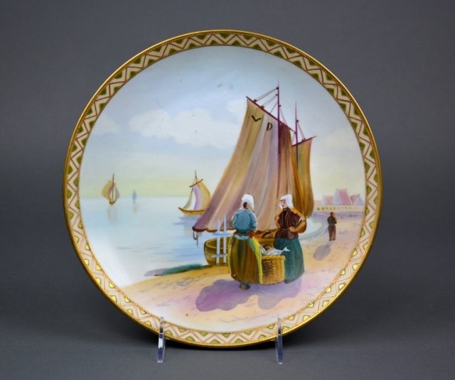 Nippon Porcelain Plaque: - Hand painted with European Dutch scene of sailboats and women with baskets of fish, gilt border. Green M-in-Wreath. Dia 26 cm. (10 in.)