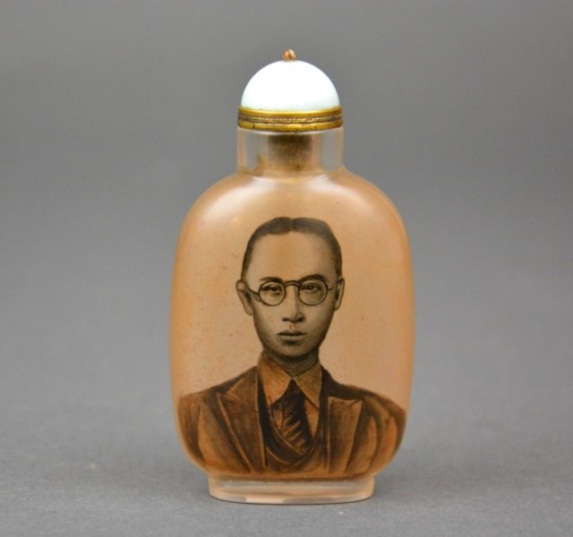 Chinese reverse painted glass snuff bottle: - of a young man in suit and a poem in calligraphy on verso. With brass mounts and jadeite stopper.