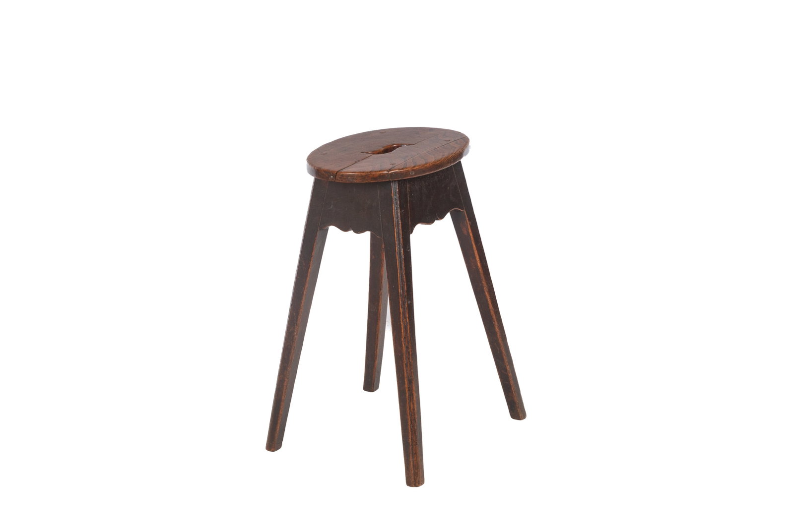 SMALL GEORGIAN ENGLISH c. 1790 TABLE: Joined stool with shaped apron, splayed legs. Elm oval top with pierced hand hold. English, 1790-1820.H. 20 1/2in x W. 13in x D. 9 1/4in