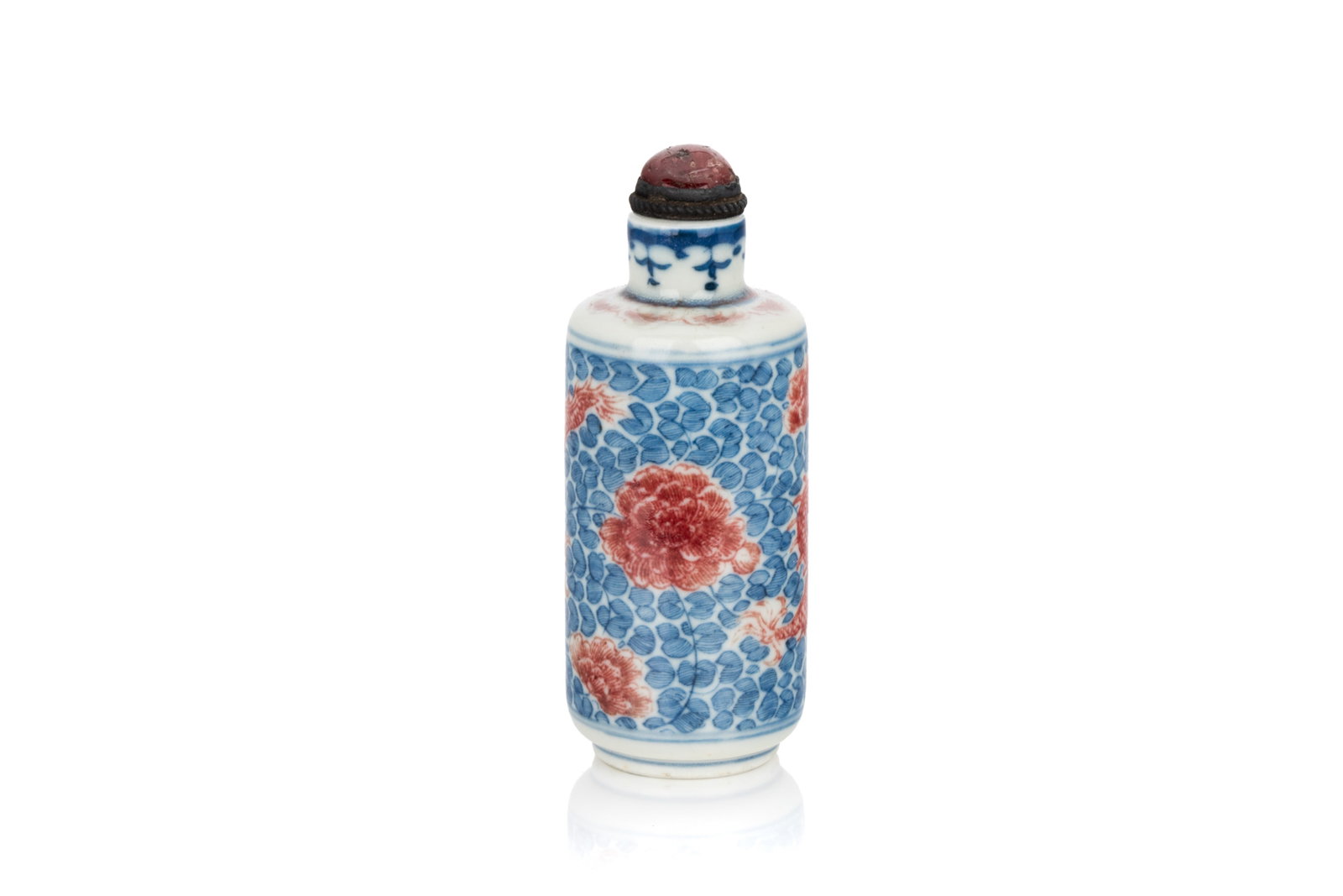 BLUE & WHITE & COPPER RED DRAGON SNUFF BOTTLE: Of cylindrical form with a short neck. The body decorated with a dragon in copper red on a leafy lotus ground. Metal and quartz stopper. H. 8.5 cm Snuff Bottle Collection of John Mckeggie Rogers (1905