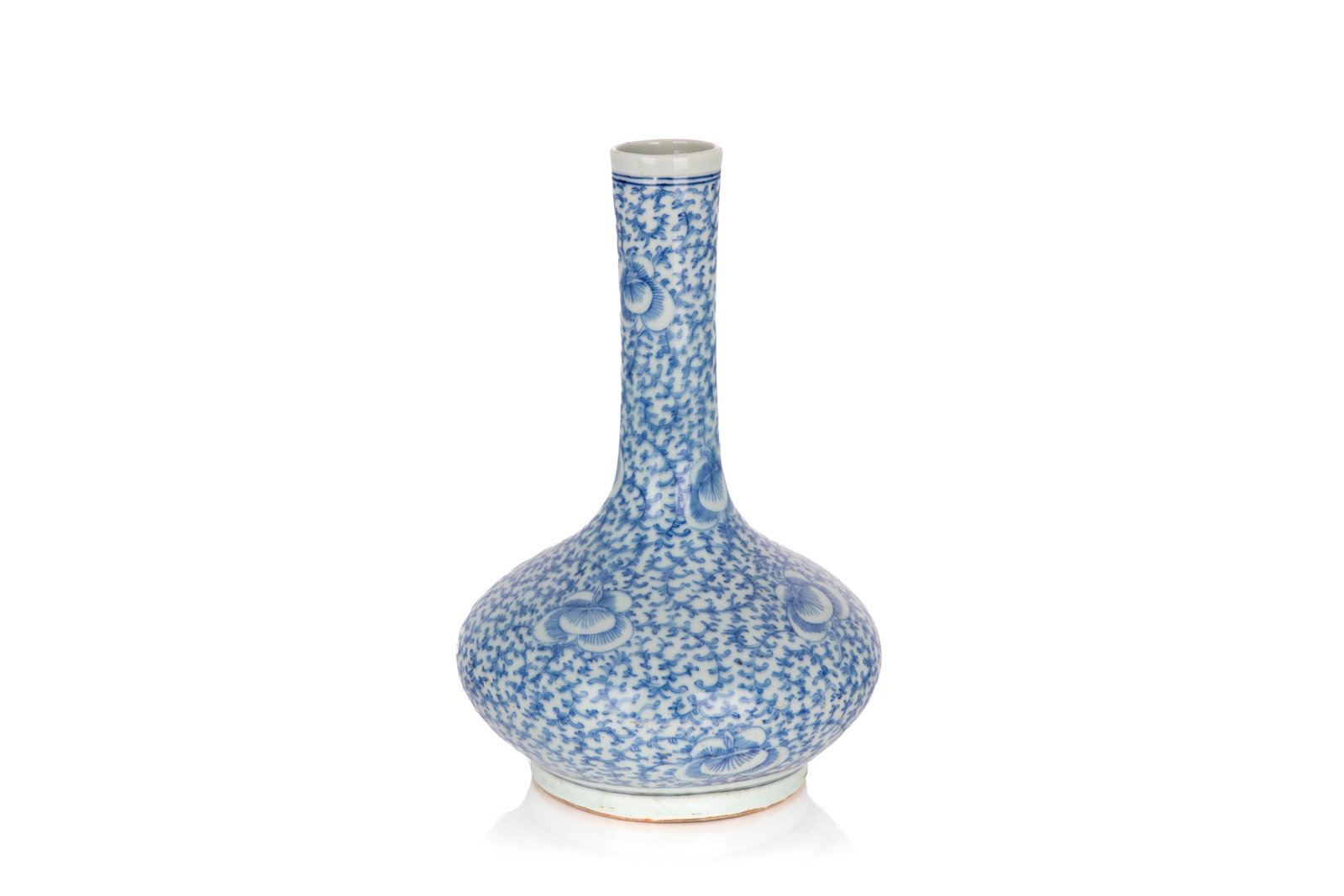 BLUE AND WHITE BATAVIA WARE FLORAL BOTTLE VASE: Of compressed bulbous form surmounted by a long neck. The body is decorated with scrolling vines and blossoming flowers. No mark to the base. Qing dynasty, 19th century. H. 33 cm From the private coll