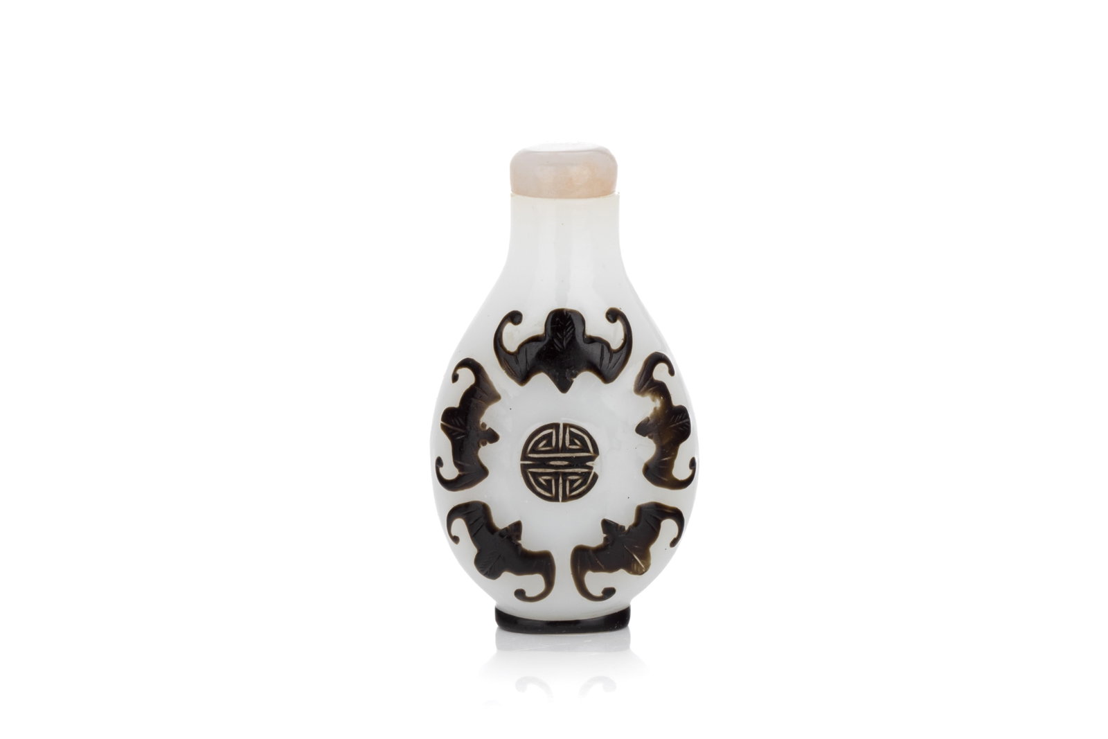 BLACK OVERLAY WHITE GLASS WUFU SNUFF BOTTLE: Of flattened oval form. Carved in a black overlay to the white ground with wufu (five bats) motif surrounding a shou character symbolizing longevity on both sides. Whitejade stopper. H. 7.5 cm Snuff B