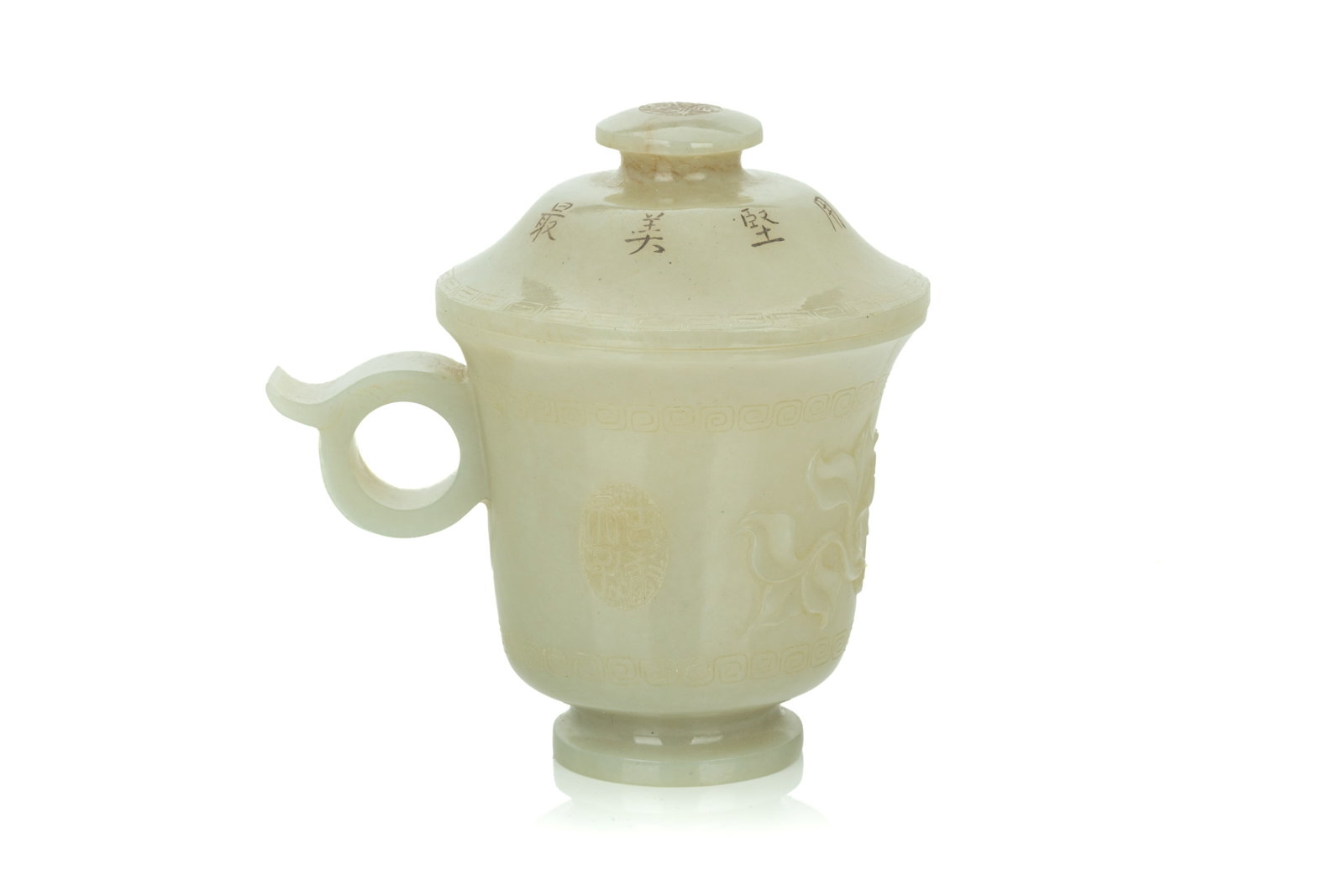 PALE CELADON JADE CUP AND COVER: The exterior of the cup decorated with two seals and foliate in between two scrolling bands, ring handle to one side. The cover inscribed with eight characters, the finial with four-character seal. Ex