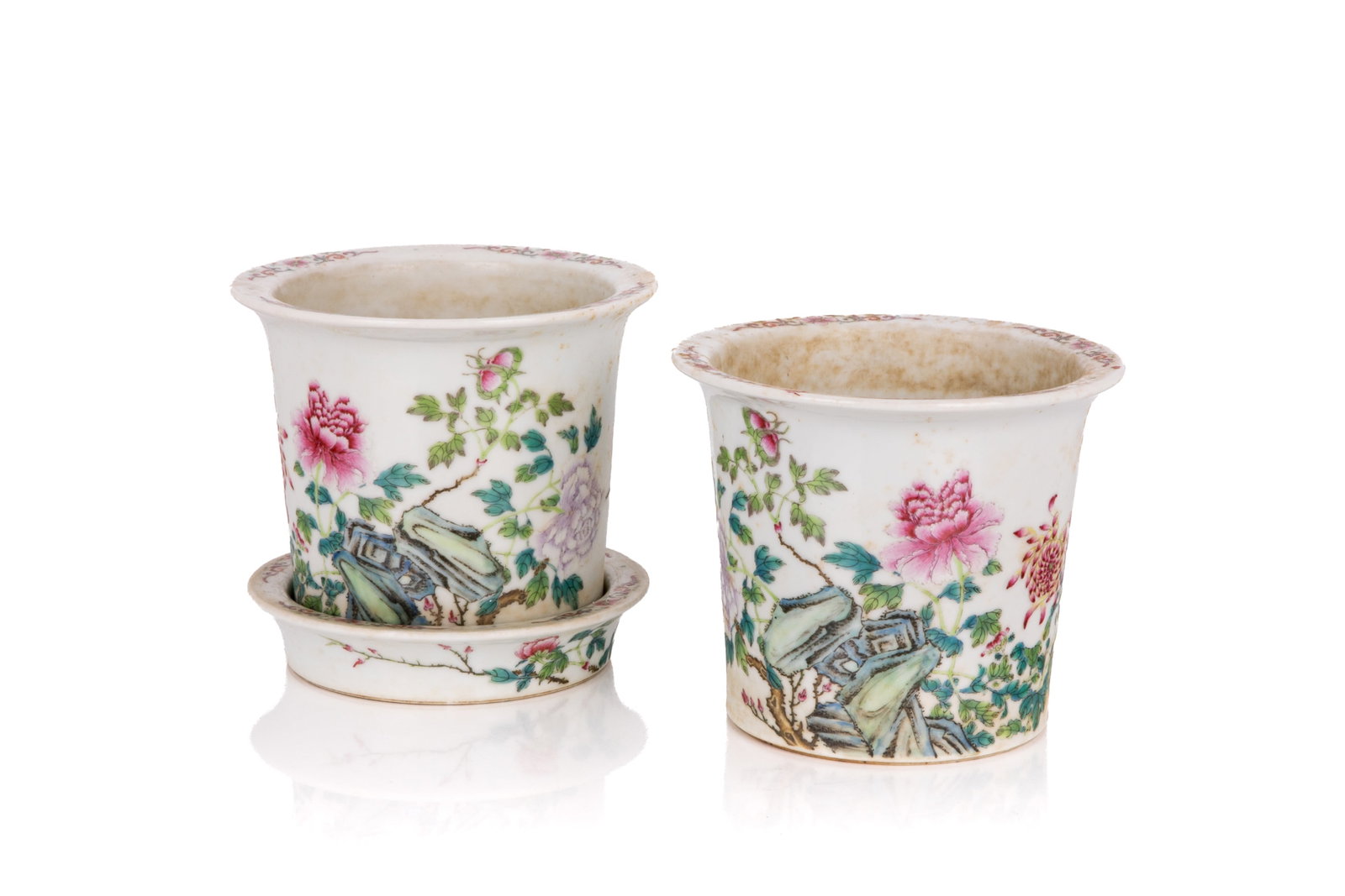PAIR OF FAMILLE ROSE FLORAL PORCELAIN PLANTERS: Of tapered cylindrical form. The exterior decorated with blossoming peonies and chrysanthemums. The everted rim with four floral sprays. Six-character Qianlong mark to the underside. With one stand of