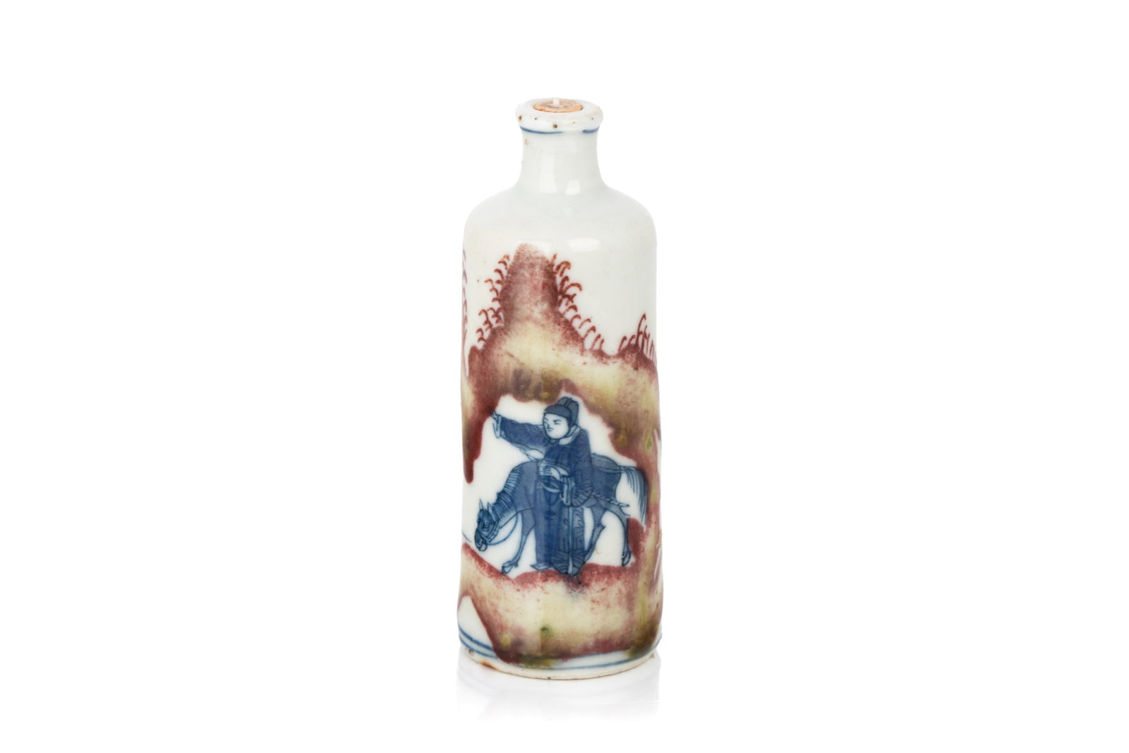 BLUE & WHITE & COPPER RED FIGURAL SNUFF BOTTLE: Of cylindrical form. The body decorated with an equestrian and a male figure enclosed in a copper-red decorated rocky landscape. Six-character Yongzheng mark to the underside. H. 7.5 cm