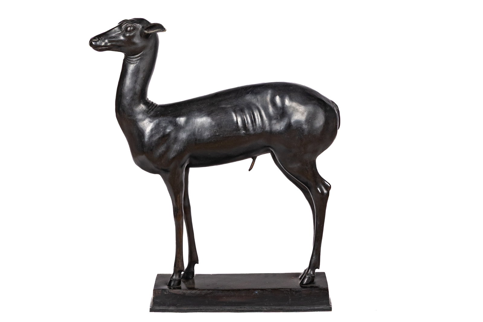 BRONZE SCULPTURE OF A YOUNG FAWN: The deer after the example found at the Villa of the Papyrus in Herculaneum and preserved at the Archaeological Museum of Naples. H 33in x W 29 1/2in x D 6 1/2in