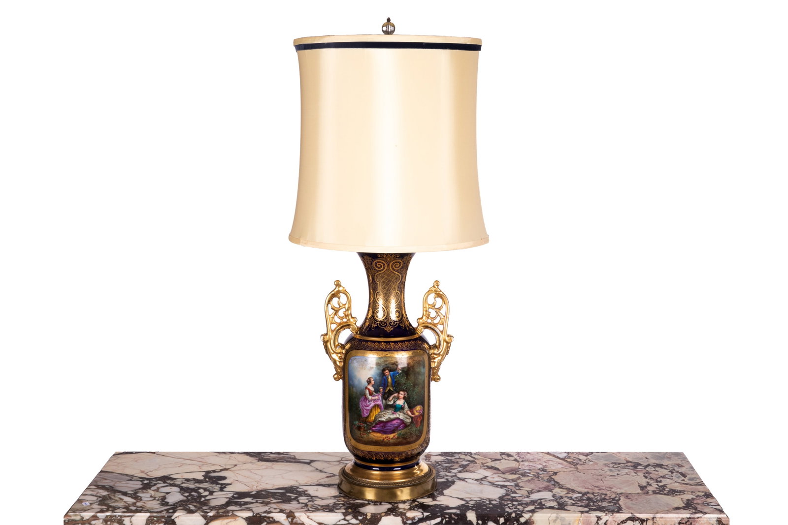 HAND PAINTED PORCELAIN VASE AS A TABLE LAMP: Cobalt vase with gilded decoration and pierced handles, hand painted scene of figures in the gardens, mounted as a table lamp. Overall H 39in H 21 1/2in