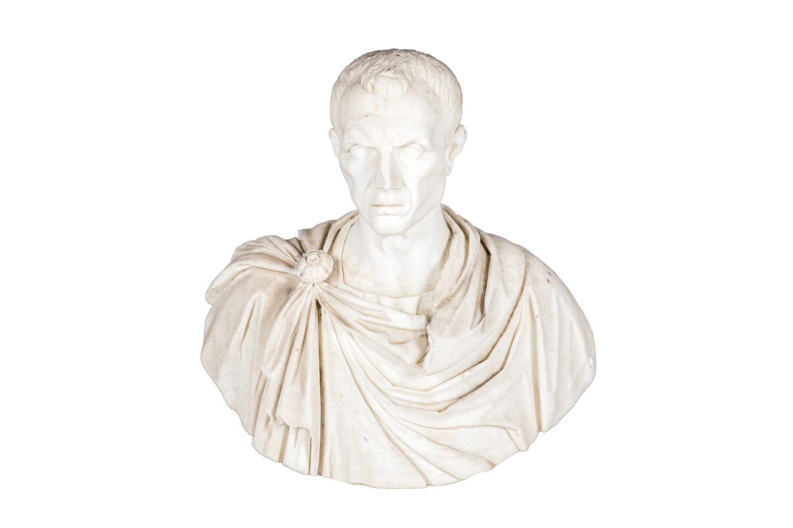 GRAND TOUR BUST OF JULIUS CEASAR: Italy, 18th century. Carved white marble bust depicting Julius Caesar wearing draped classical robes fastened with a circular brooch at the right shoulder, raised on an integral socle base. H. 23in x