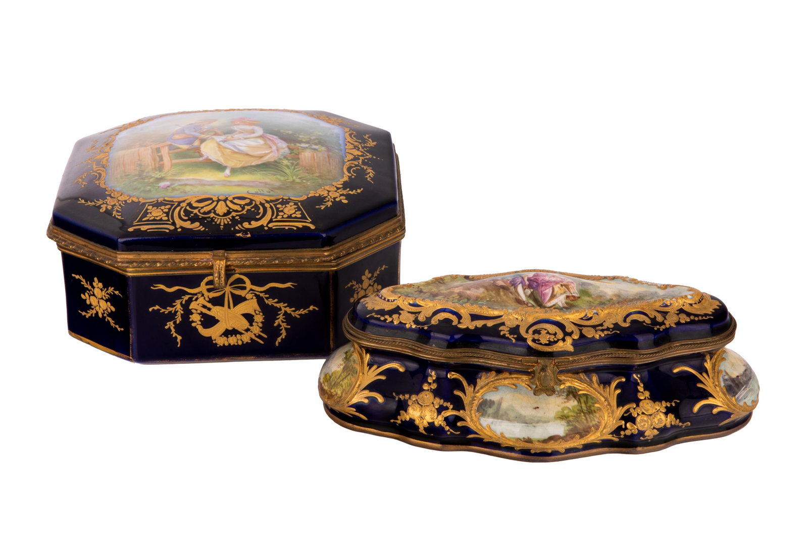 TWO FRENCH GILT AND COBALT PORCELAIN BOXES: Late 19th-century French Sevres-style cobalt blue porcelain caskets both with romantic Rococo courting scenes, the larger signed Collot, marks for Chateau des Tuileries, the smaller with landscaped co