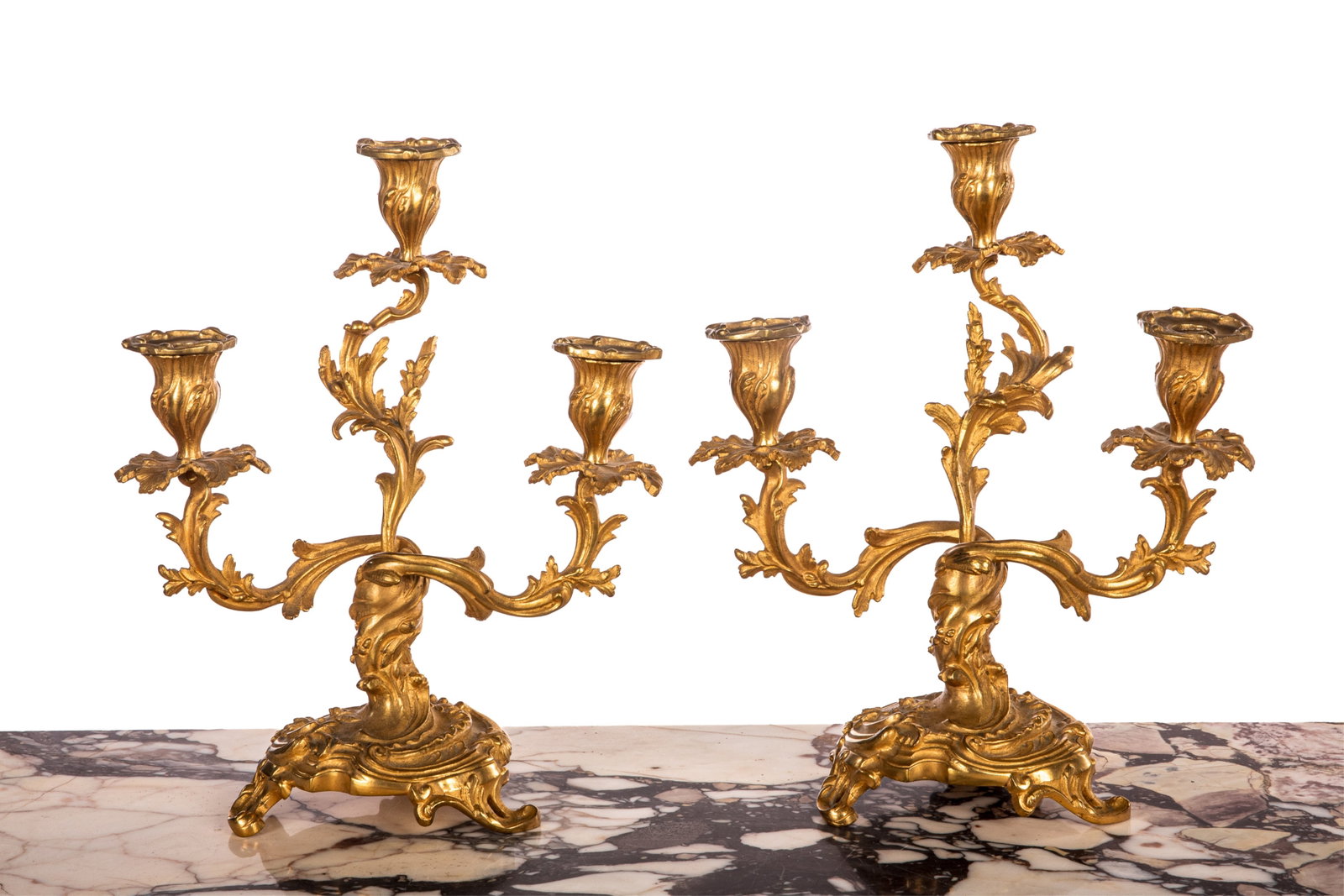 PAIR OF FRENCH BRONZE ROCOCO CANDELABRA: Foliate gilt bronze three branch candelabra raised on tripod feet, French, 19th C. H 12in