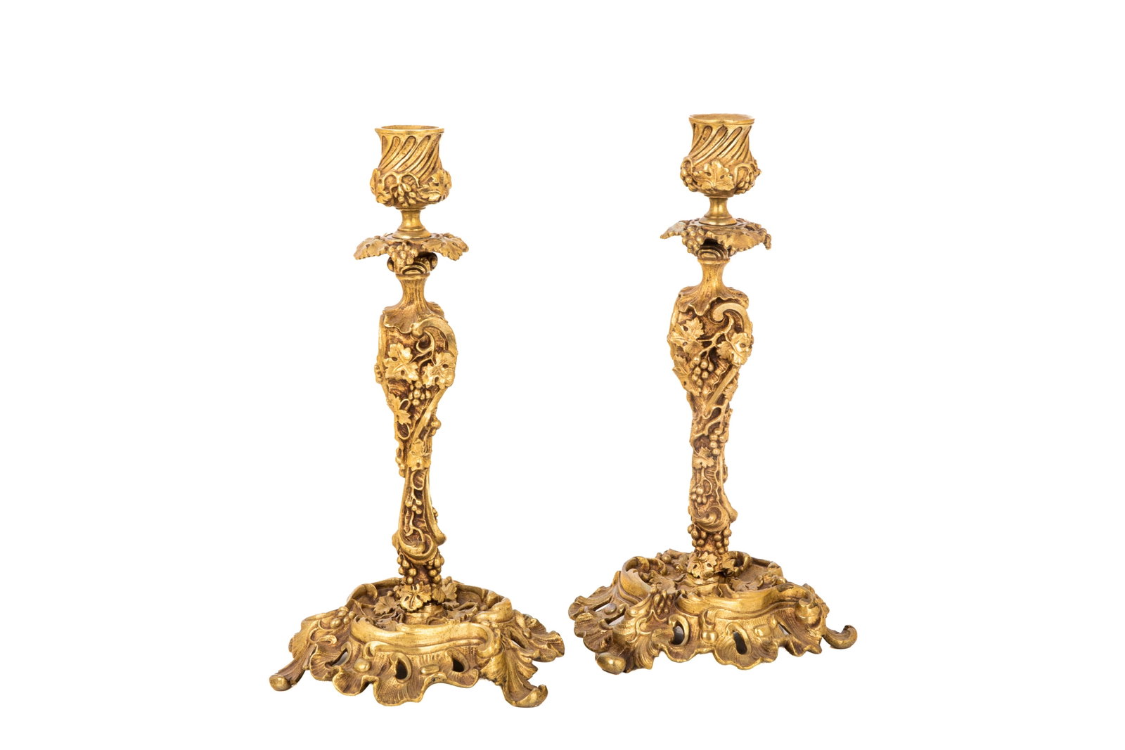 FRENCH ROCOCO REVIVAL CANDLESTICKS: Grapevines and stylized floral elements serve as the dominant decorative motif throughout the stems, bases and sconces, French, 19th C. H. 11 1/2in (29cm) x 6in (15.5cm)