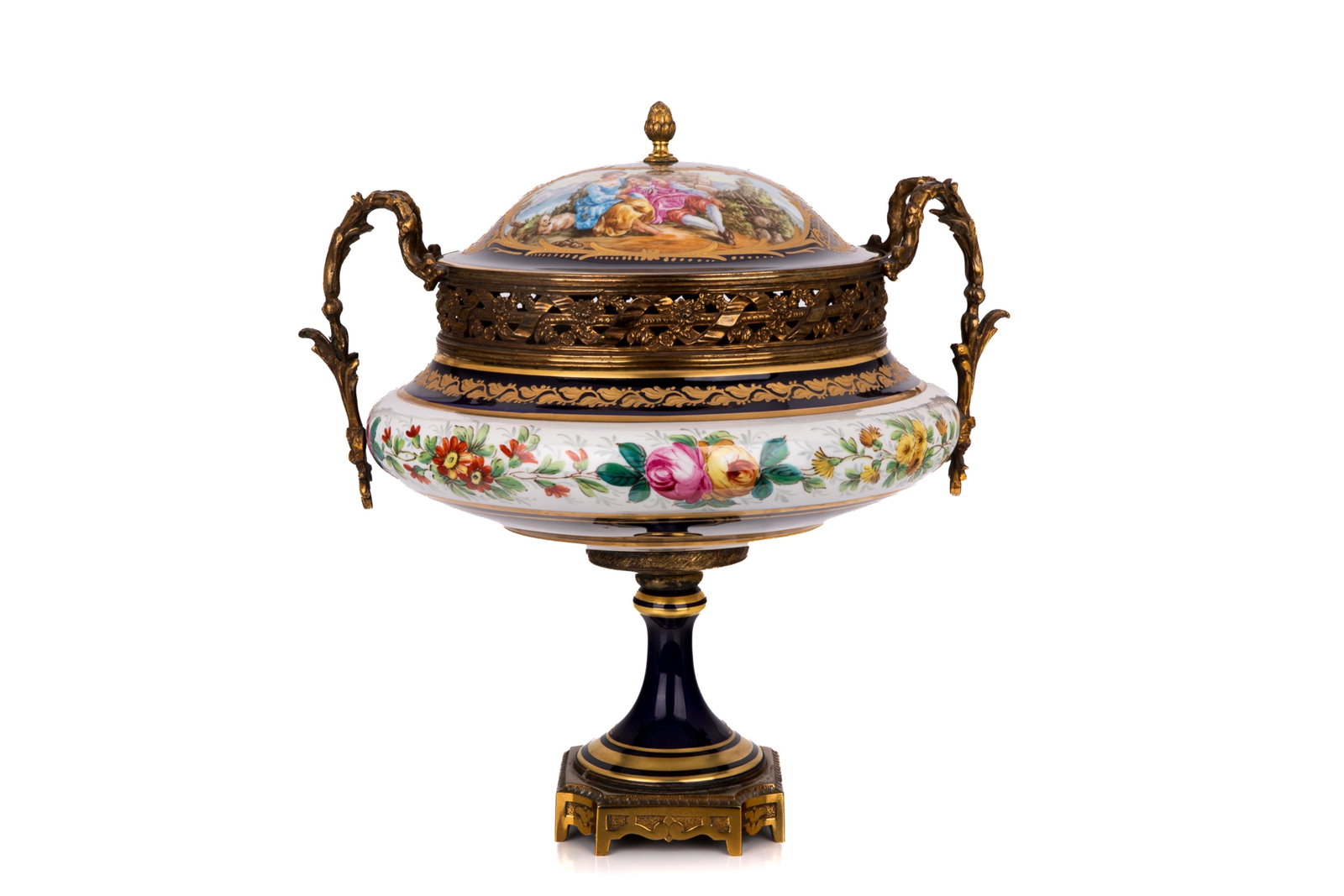 20TH C. FRENCH BRONZE MOUNTED COVERED TAZZA: A decorative French S?vres style bronze or brass-mounted porcelain covered tazza, 20th century. The domed cover depicting a pastoral courting couple in a romantic landscape. L. 13in x H. 14 1/8in