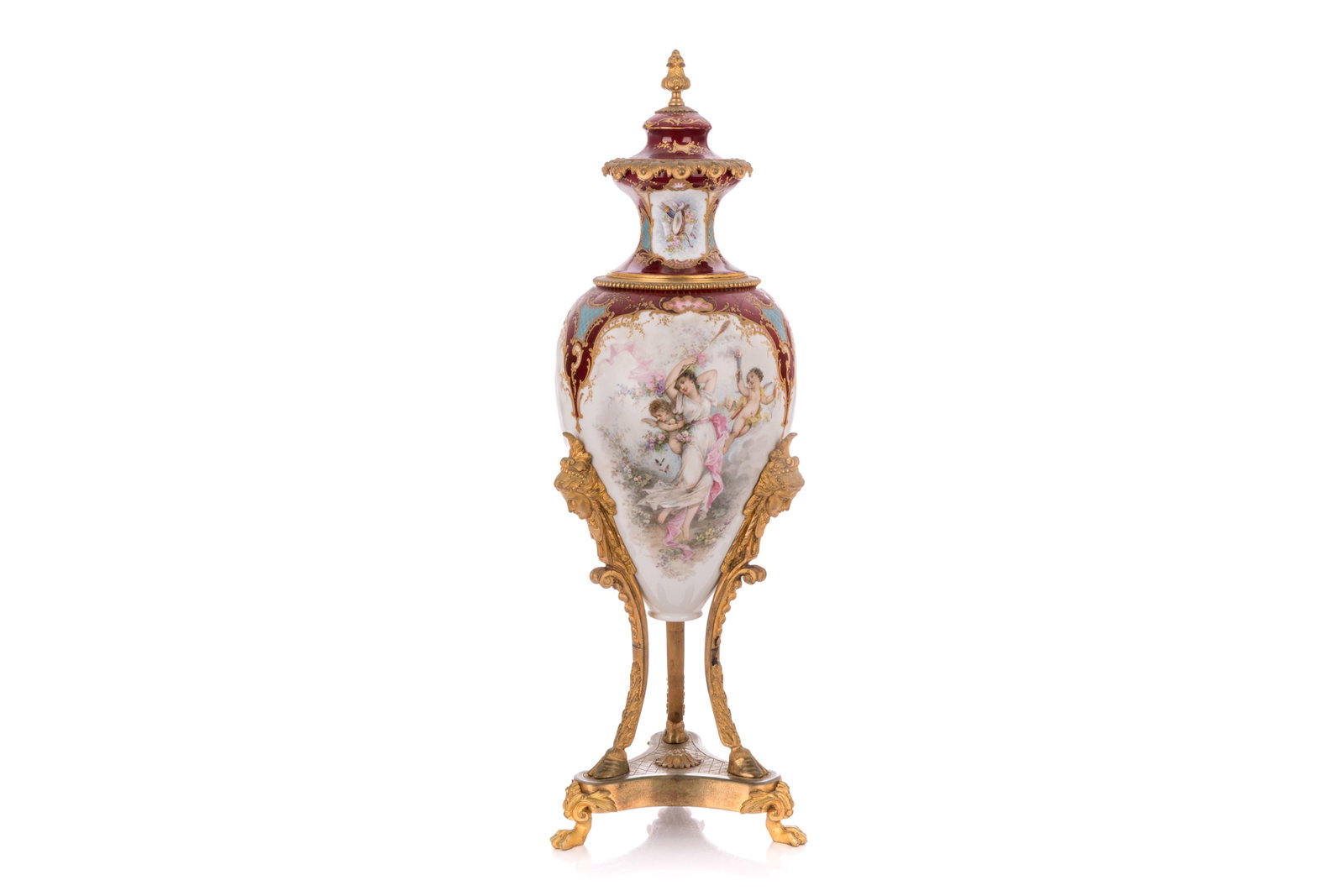 CONTINENTAL SEVRES-STYLE MOUNTED PORCELAIN URN: A large and decorative Continental Sevres-style porcelain covered urn, late 19th to early 20th century. The body is finished in a rich claret-red ground with gilt embellishments. Central reserve depic