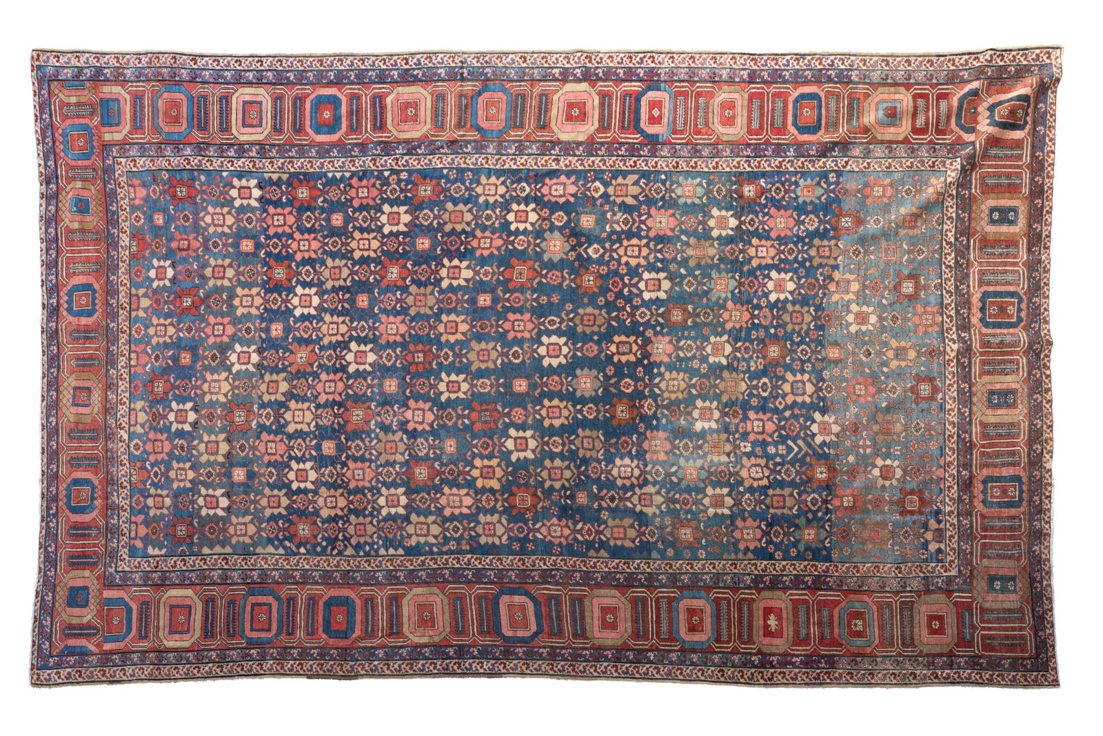 ANTIQUE HERIZ CARPET: Natural blue dyed carpet with stylized flowers, geometric chain border, Probably 19th C. 17ft 7in x 11ft 1in