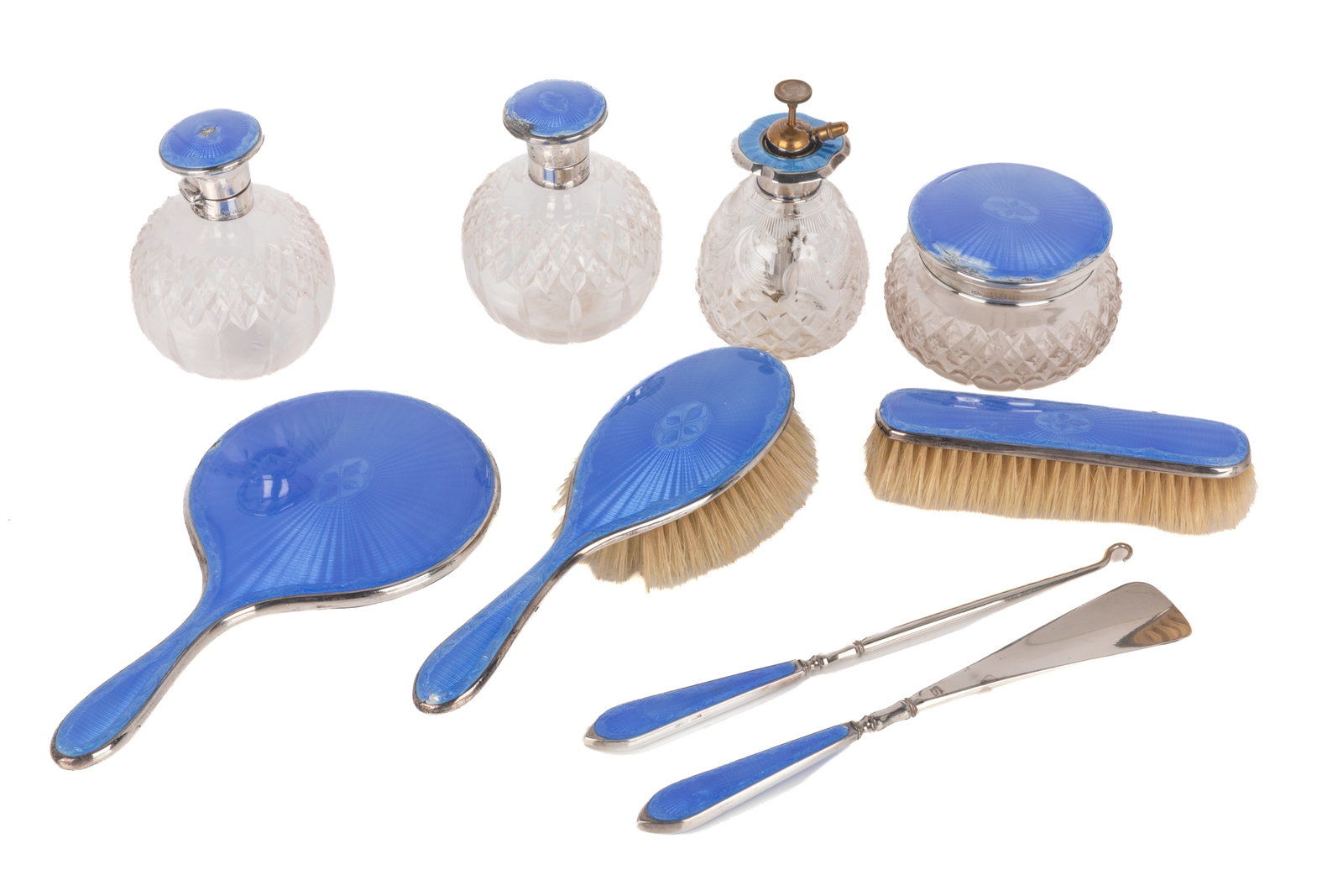 9 pc. ART DECO GUILLOCHE ENAMEL SILVER VANITY SET: Comprising 1 hand mirror; 1 hairbrush; 1 clothes brush; 1 shoehorn; 1 button hook; 1 cut glass jar with enamel lid; 1 cut glass perfume atomizer; and 2 cut glass bottles. Hallmarked Asprey & Co Ltd, B