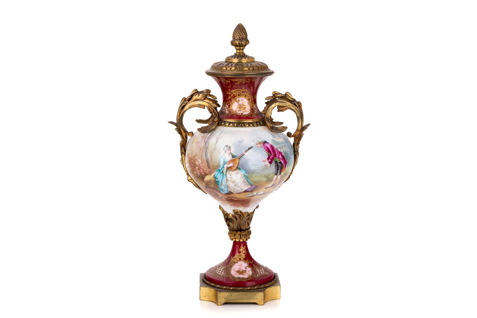 FRENCH PORCELAIN & BRONZE MOUNTED URN: French Sevres-style porcelain and gilt-bronze mounted lidded urn. The baluster-form body features a rich, deep raspberry-pink ground accented with elegant gilded floral cartouches. The central hand-pa