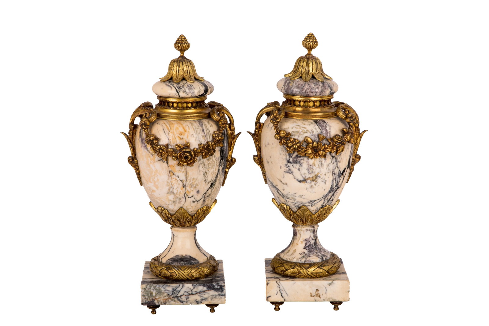 PAIR OF BRONZE AND MARBLE URNS: 19th century French Louis XVI-style urns, featuring a white-and-grey marble body adorned with detailed ormolu mounts. Designed with ornamental garlands, classical handles, and a pine cone finial on th