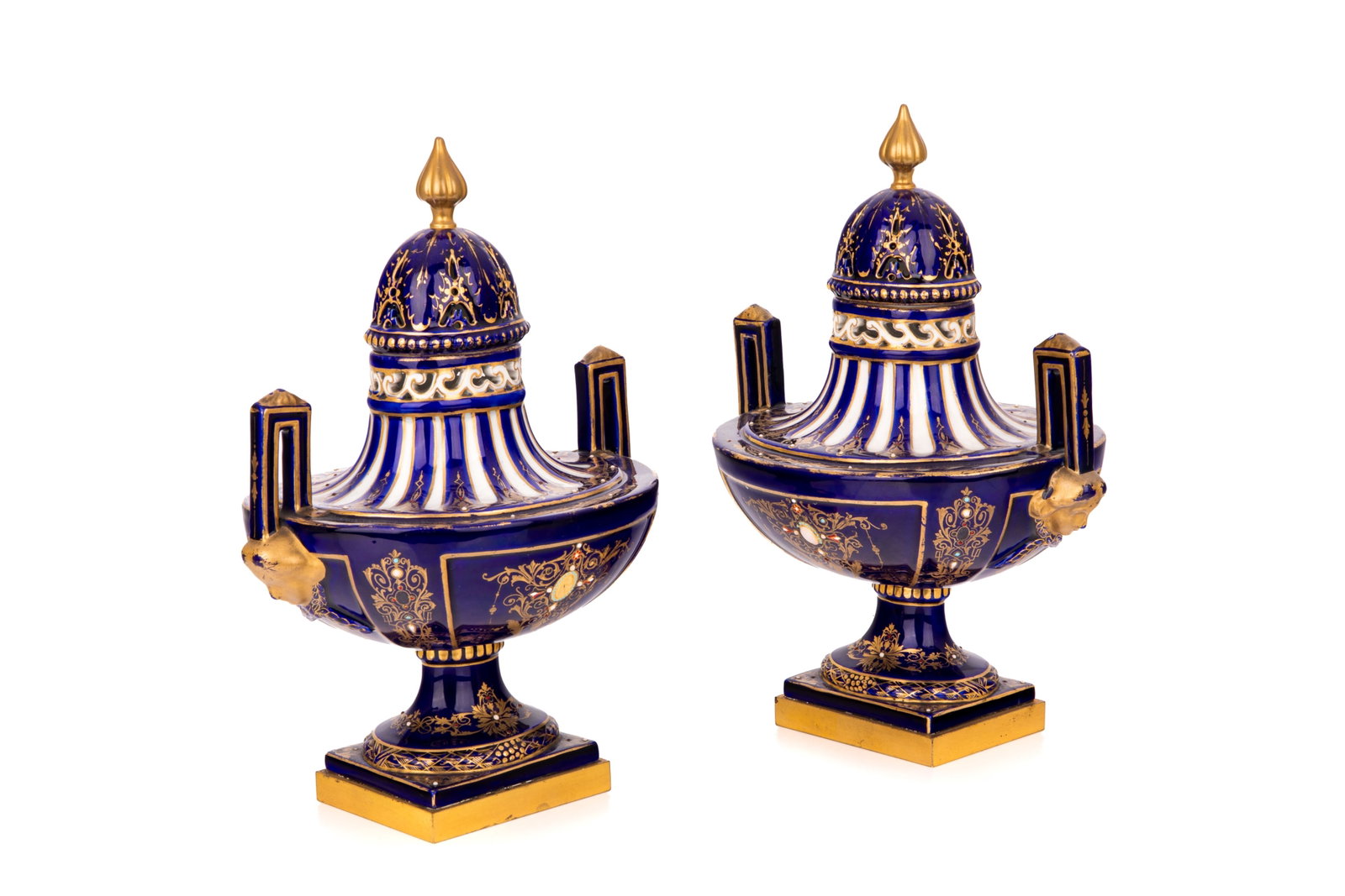 PAIR OF FRENCH PORCELAIN POT POURRI URNS: A pair of French S?vres style porcelain lidded urns in cobalt with enamel jewelling, late 19th century. L. 7 1/4in x H. 10in (18.4cm x 25.4cm)
